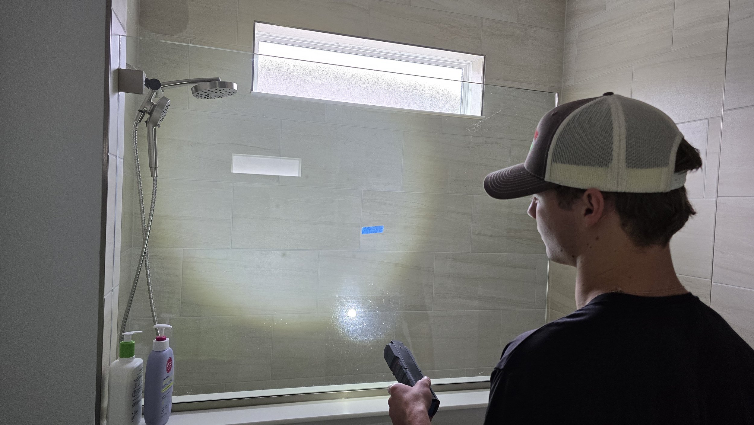 New construction shower enclosure glass scratch repair at Woodland Preserve Parrish — Glass Restoration Inc. the glass restoration specialists for Manatee County 55+ communities