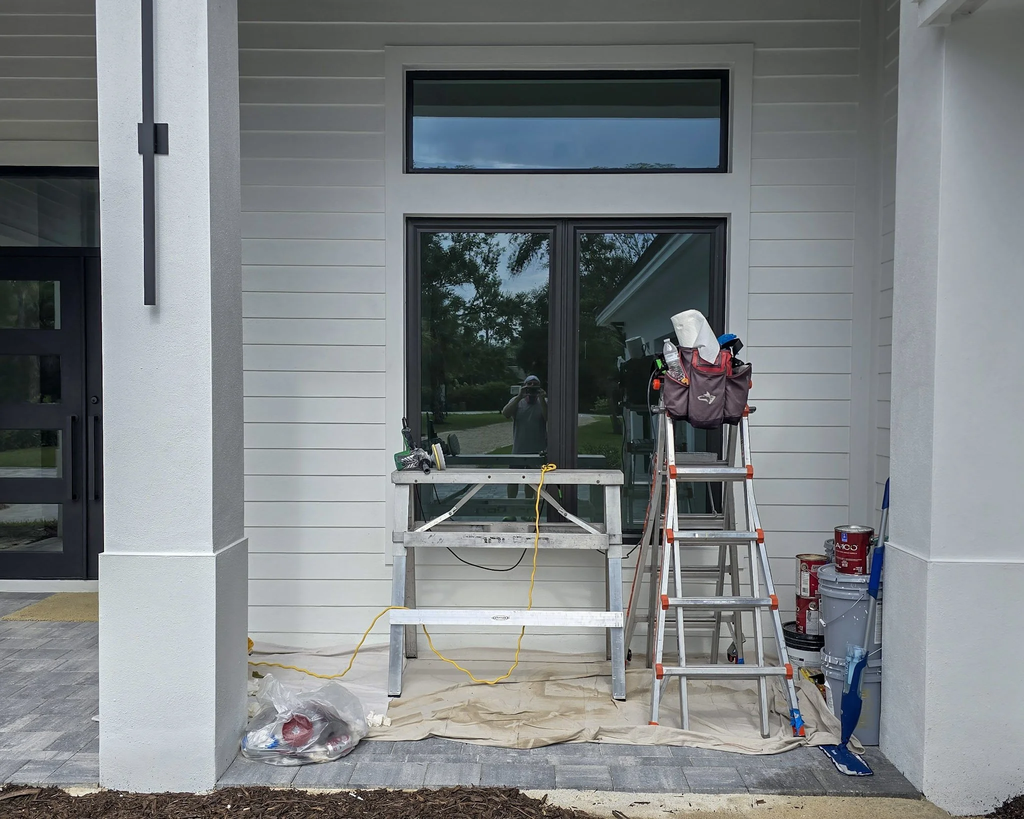 Glass Restoration Inc. professional platform setup at a new construction home at Prosperity Lakes Parrish FL — restoring a high transom window — the glass restoration specialists serving northern Manatee County builders and homeowners