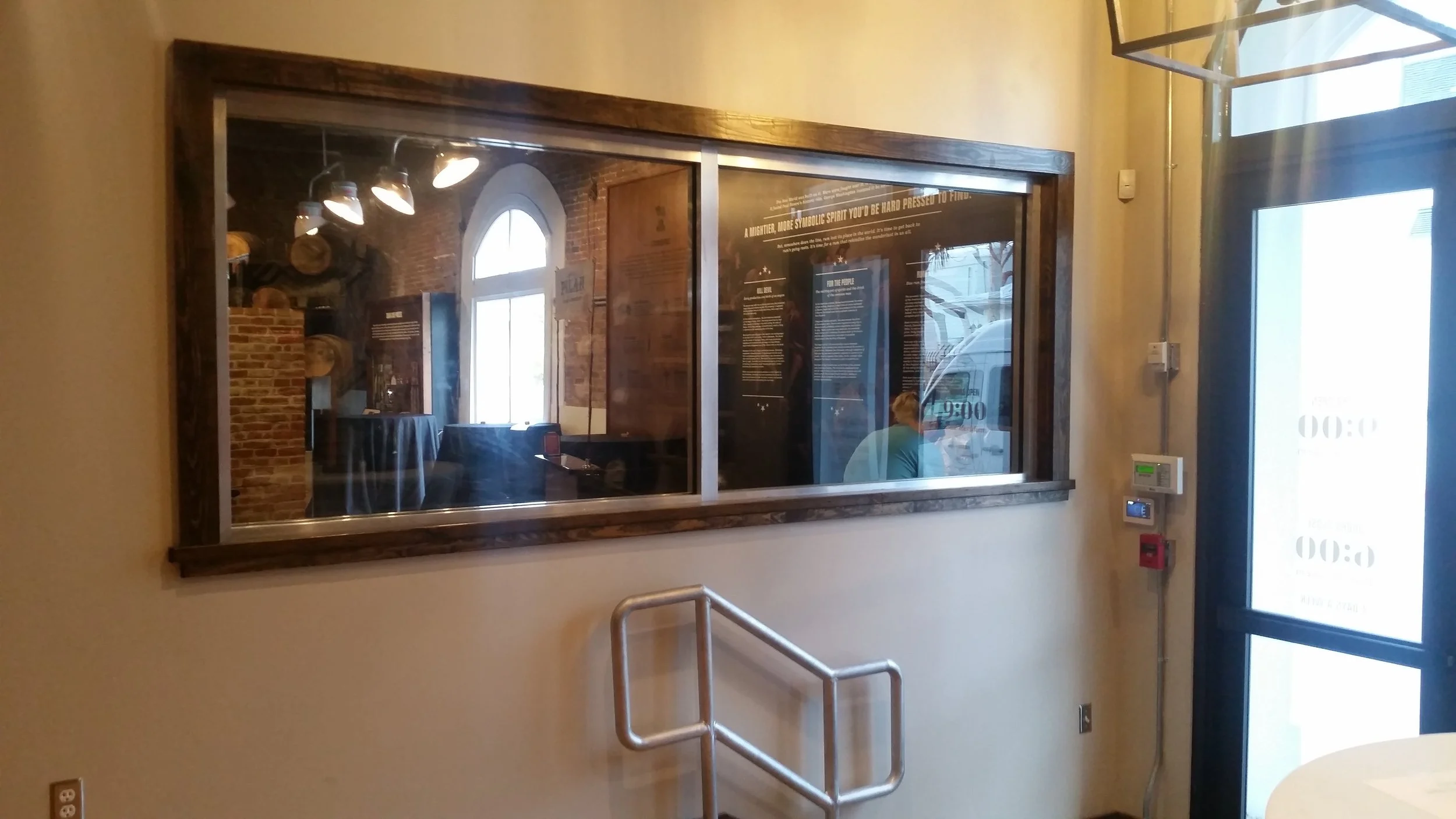 Fire rated glass partition between the gift shop and distillery at Papa's Pilar Rum Distillery, Key West FL — restored by Glass Restoration Inc. before Grand Opening.