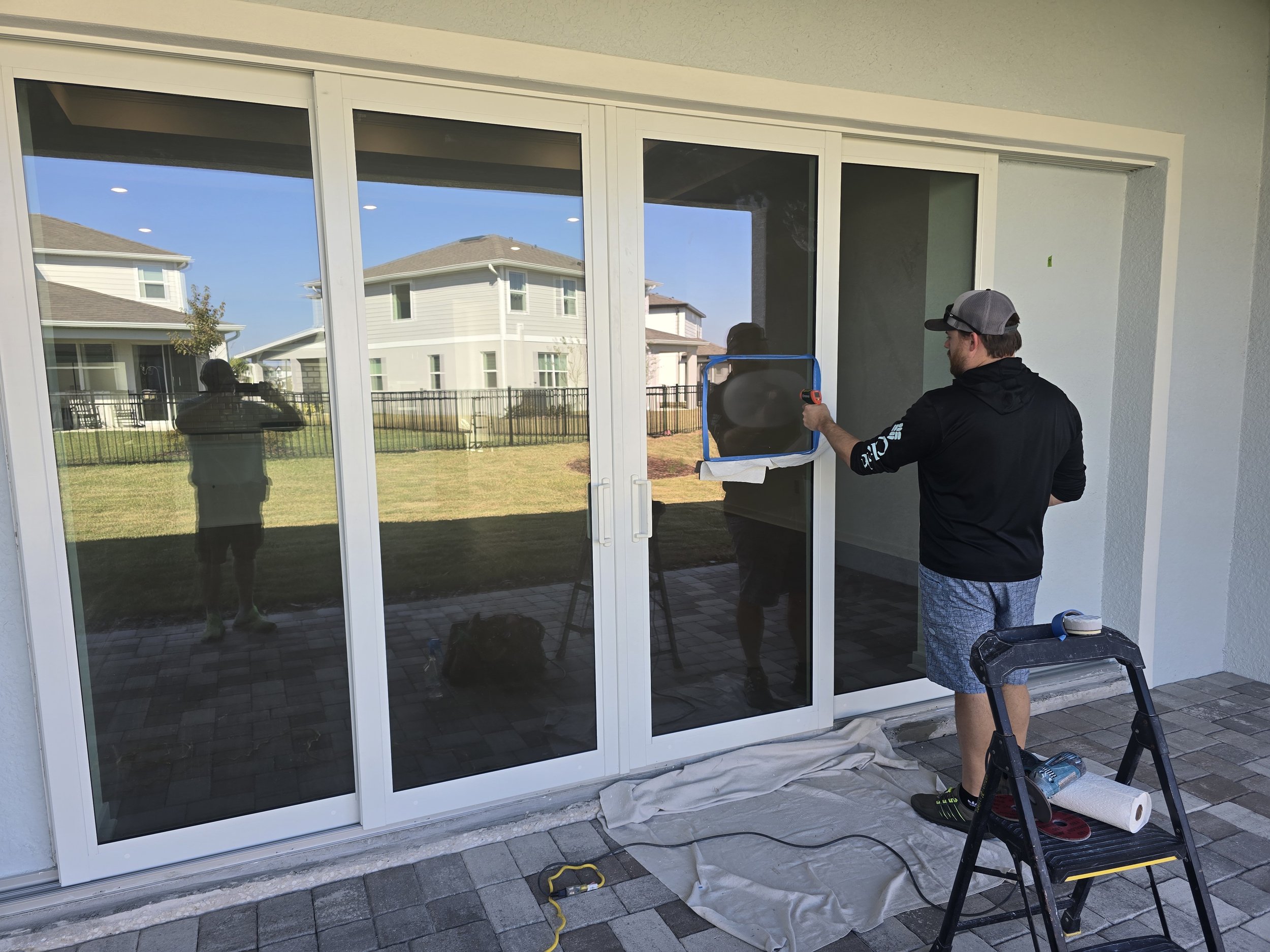 Stanton Barbas performing artisan glass restoration on a four-panel slider in Ellenton — Glass Restoration Inc. the glass restoration specialists for Manatee River homes