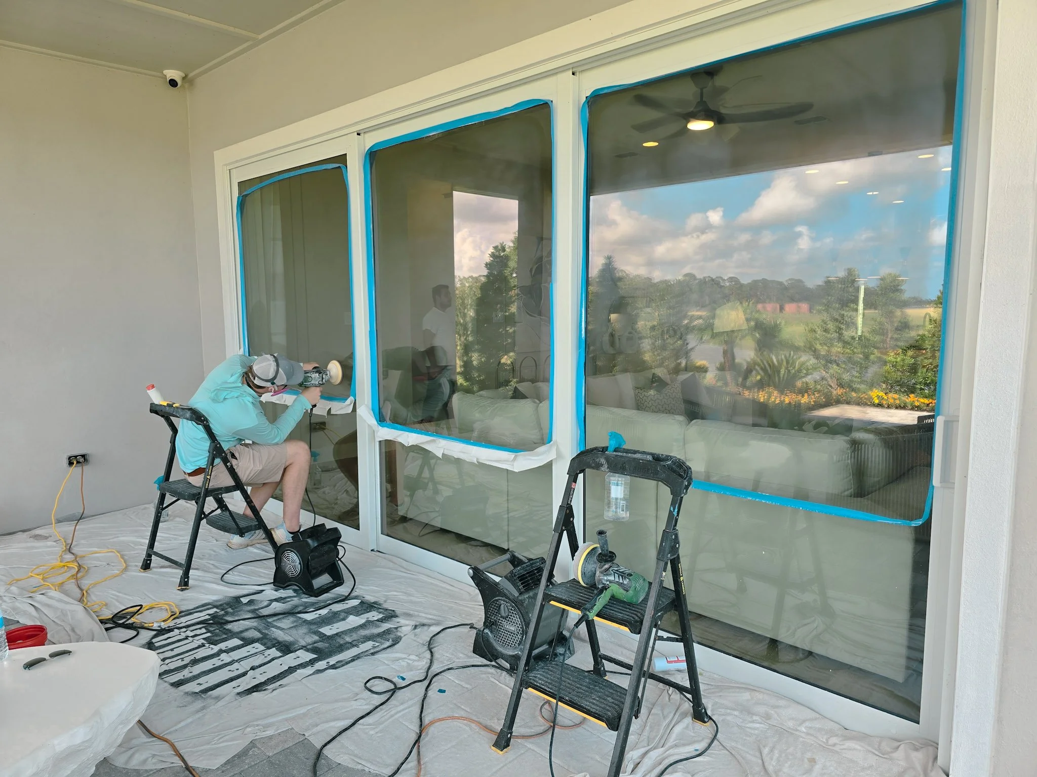 Large-scale restoration of construction scratches on newly installed sliding glass doors at a Wesley Chapel master-planned community (Epperson/Mirada) by Glass Restoration Inc.