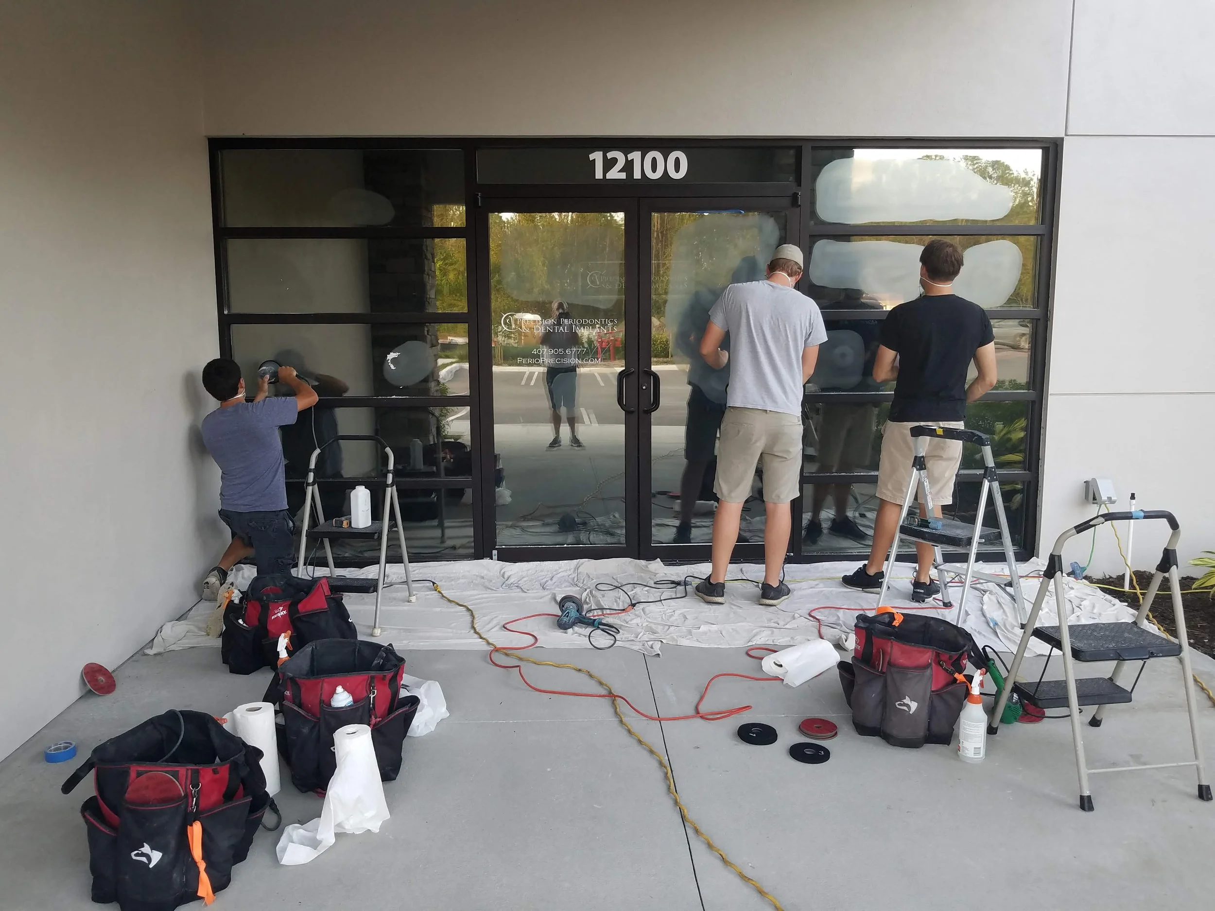 Glass Restoration Inc. artisan crew restoring entry glass at a Bradenton dental office — commercial storefront glass repair and glass polishing services Harbourwalk