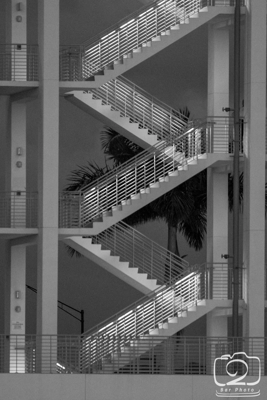 Monochrome stair tower at Nathan Benderson Park rowing venue, Sarasota FL — a landmark symbol of elevation and excellence, reflecting the standard Glass Restoration Inc. brings to every SIX88 residence on Golden Gate Point