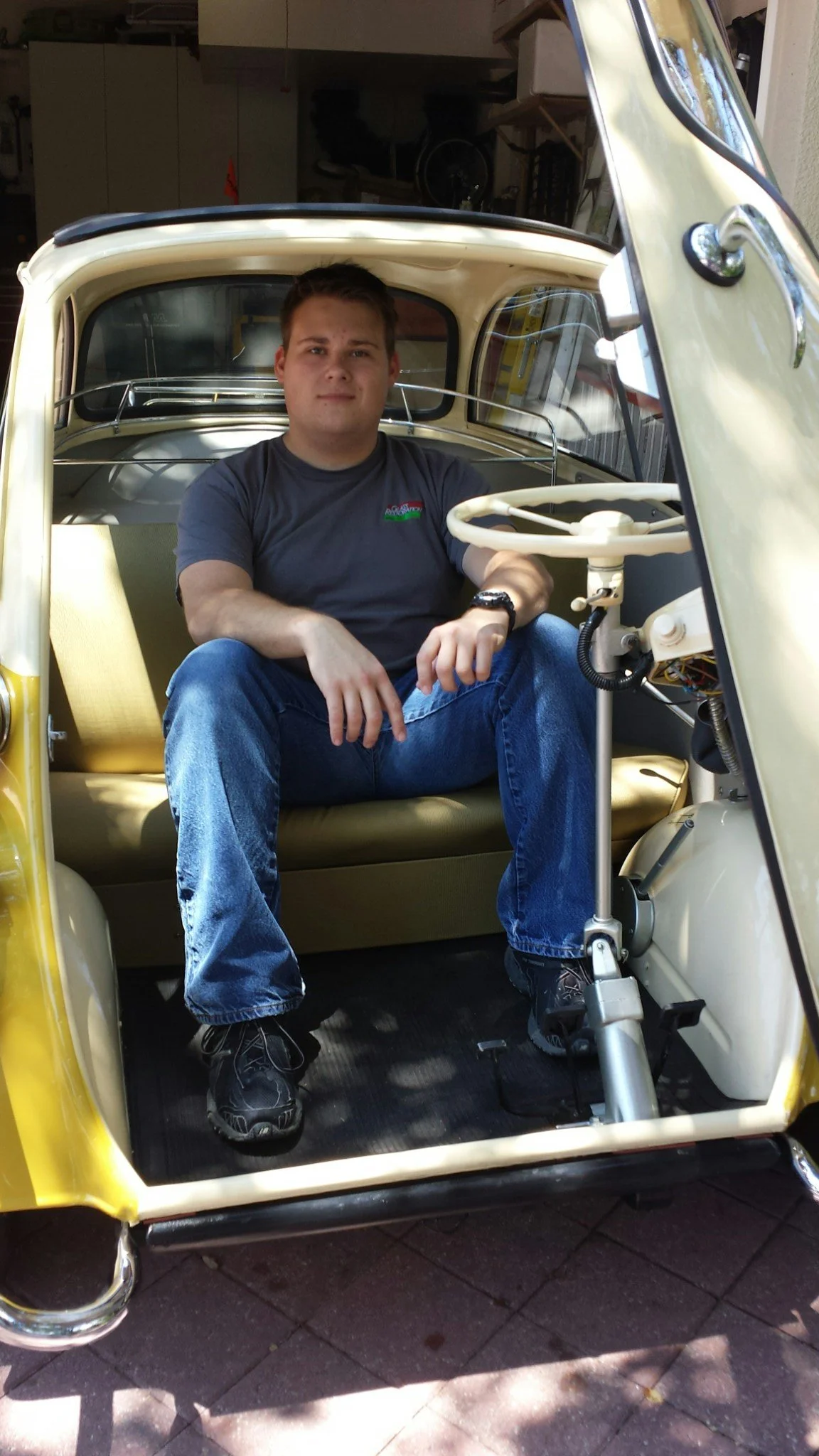 Stanton Barbas inside a 1957 BMW Isetta — the curved windshield glass on this vehicle was restored by Glass Restoration Inc. and featured in Hemmings Motor News. Watch the full restoration video →.