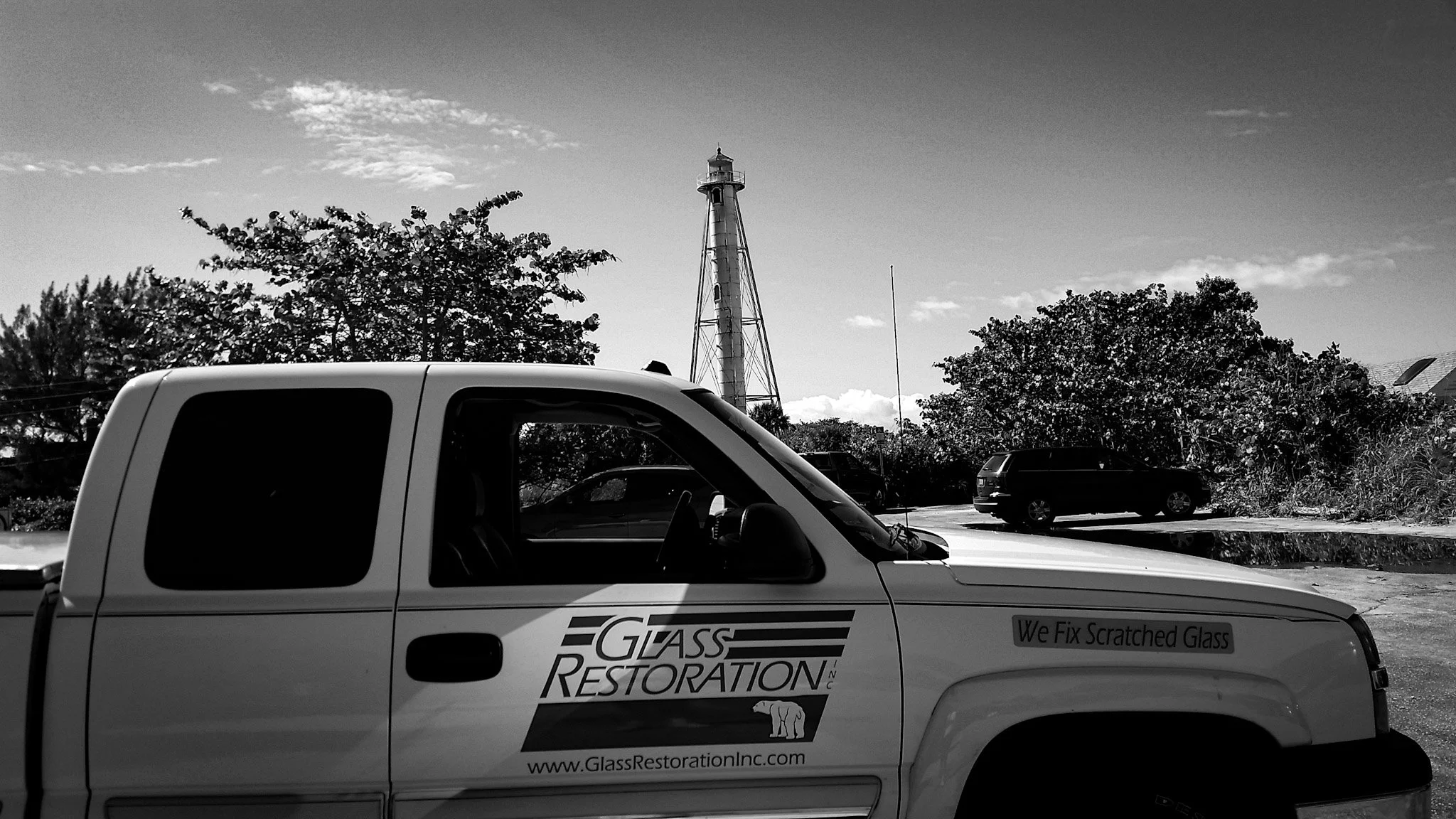 Glass Restoration Inc. service van at the Boca Grande Lighthouse on Gasparilla Island — on-site glass scratch repair and restoration serving Boca Grande FL and Charlotte County.