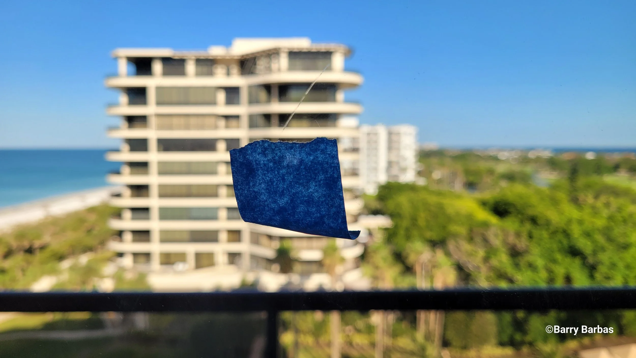 Glass scratch repair on gulf-front floor-to-ceiling glass at The Residences at The St. Regis Longboat Key Resort FL