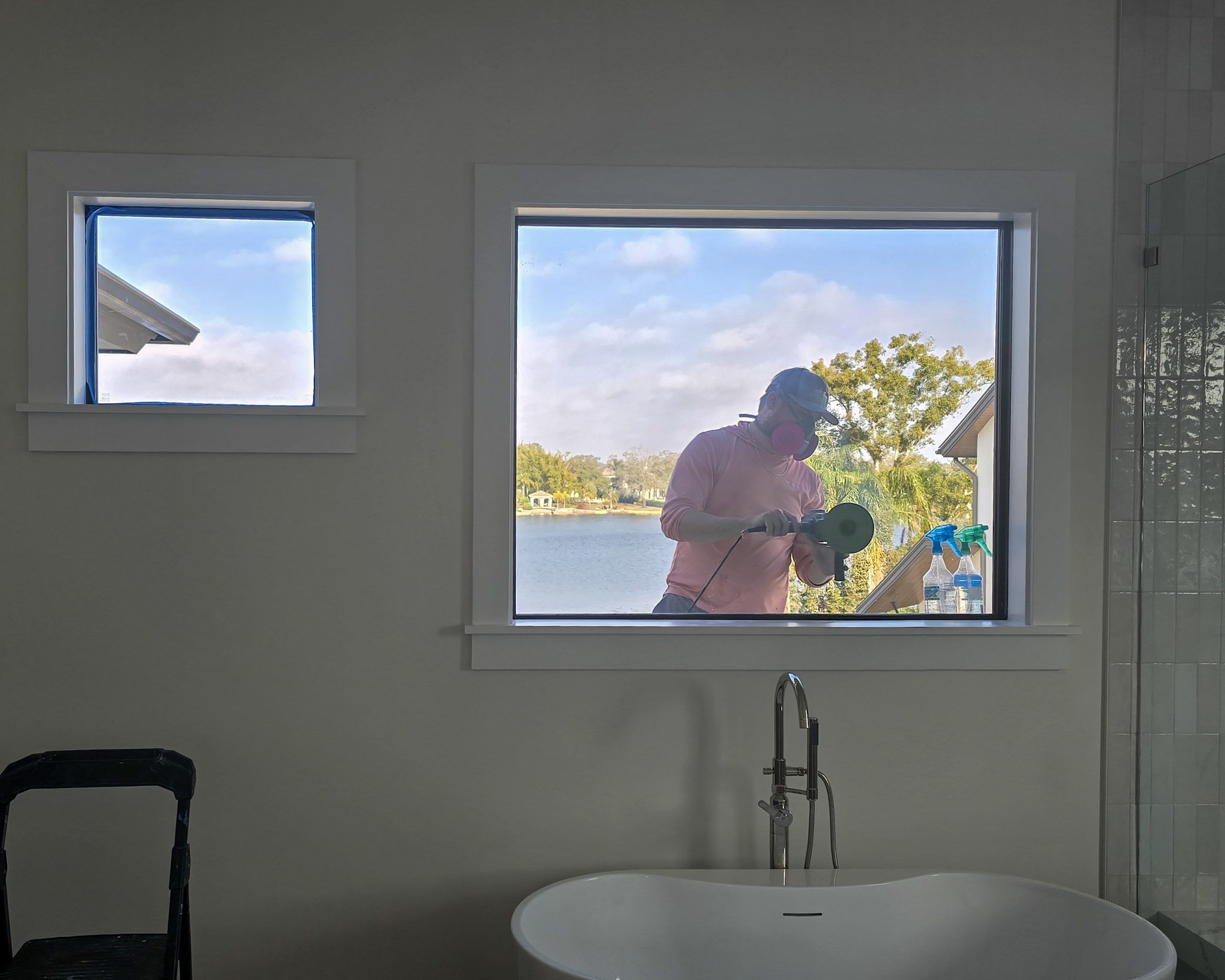 Glass Restoration Inc. technician restoring lakefront window glass at a Waterview Landing home on Lake Babcock, Punta Gorda, Florida.