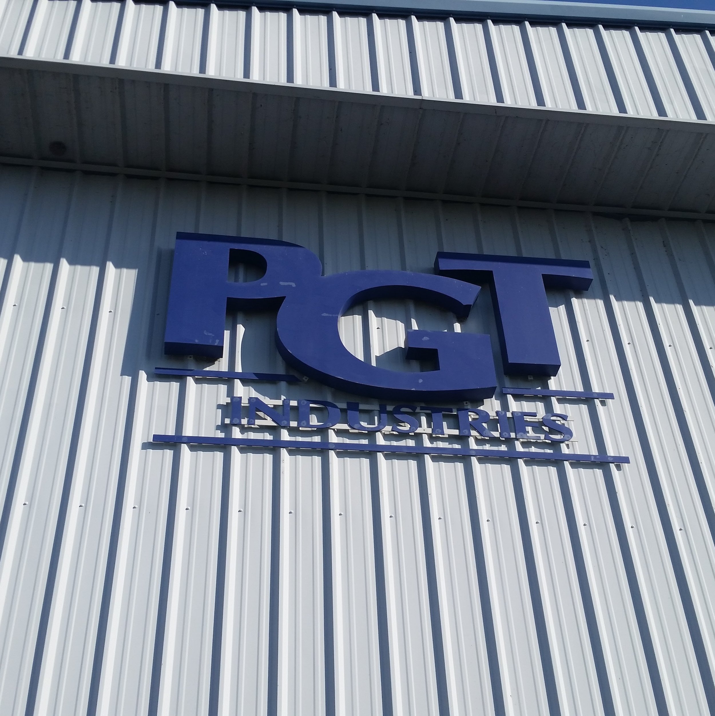PGT Industries building sign at their Nokomis Florida manufacturing facility — Glass Restoration Inc. trained PGT factory staff in professional glass restoration techniques and maintains an ongoing relationship with their warranty division