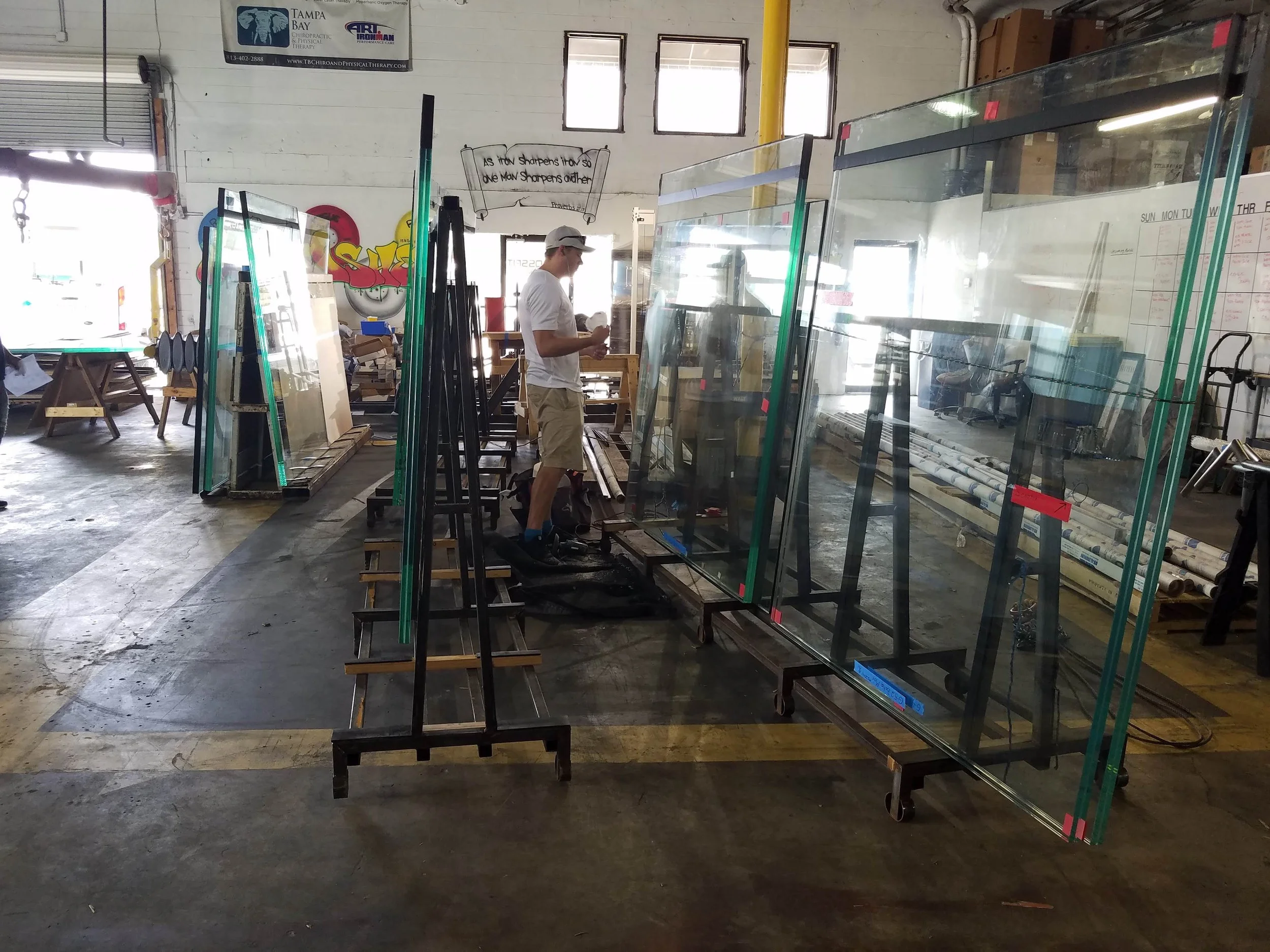 Glass Restoration Inc. working on-site inside Faour Glass — one of Florida's most prestigious glass fabricators, renowned for large panel architectural glass installations — performing restoration work directly at the source