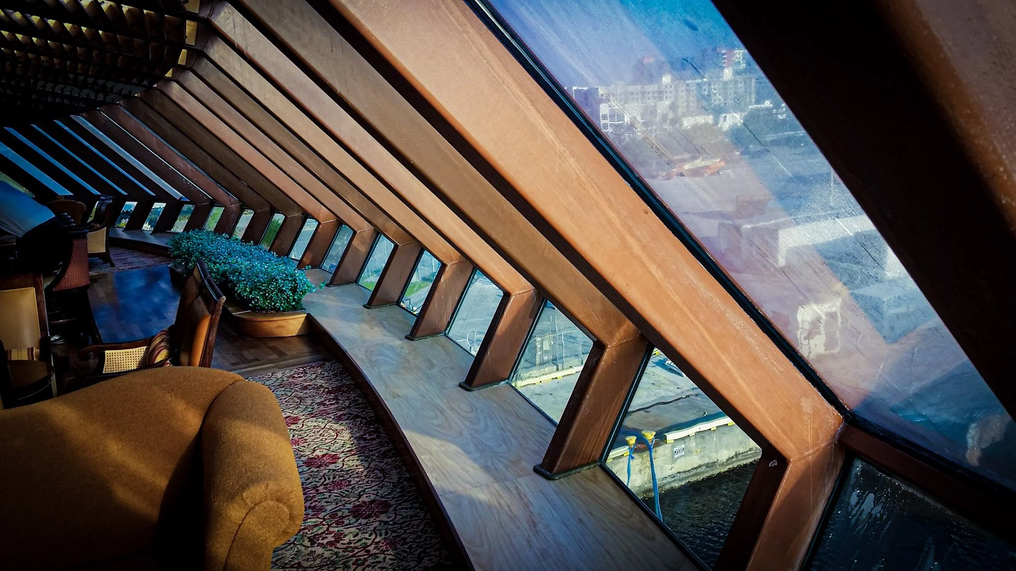 Interior of the Viking Crown observation lounge aboard Royal Caribbean's Brilliance of the Seas — vaulted glass walls and ceiling in port at Tampa FL, consulted by Glass Restoration Inc.