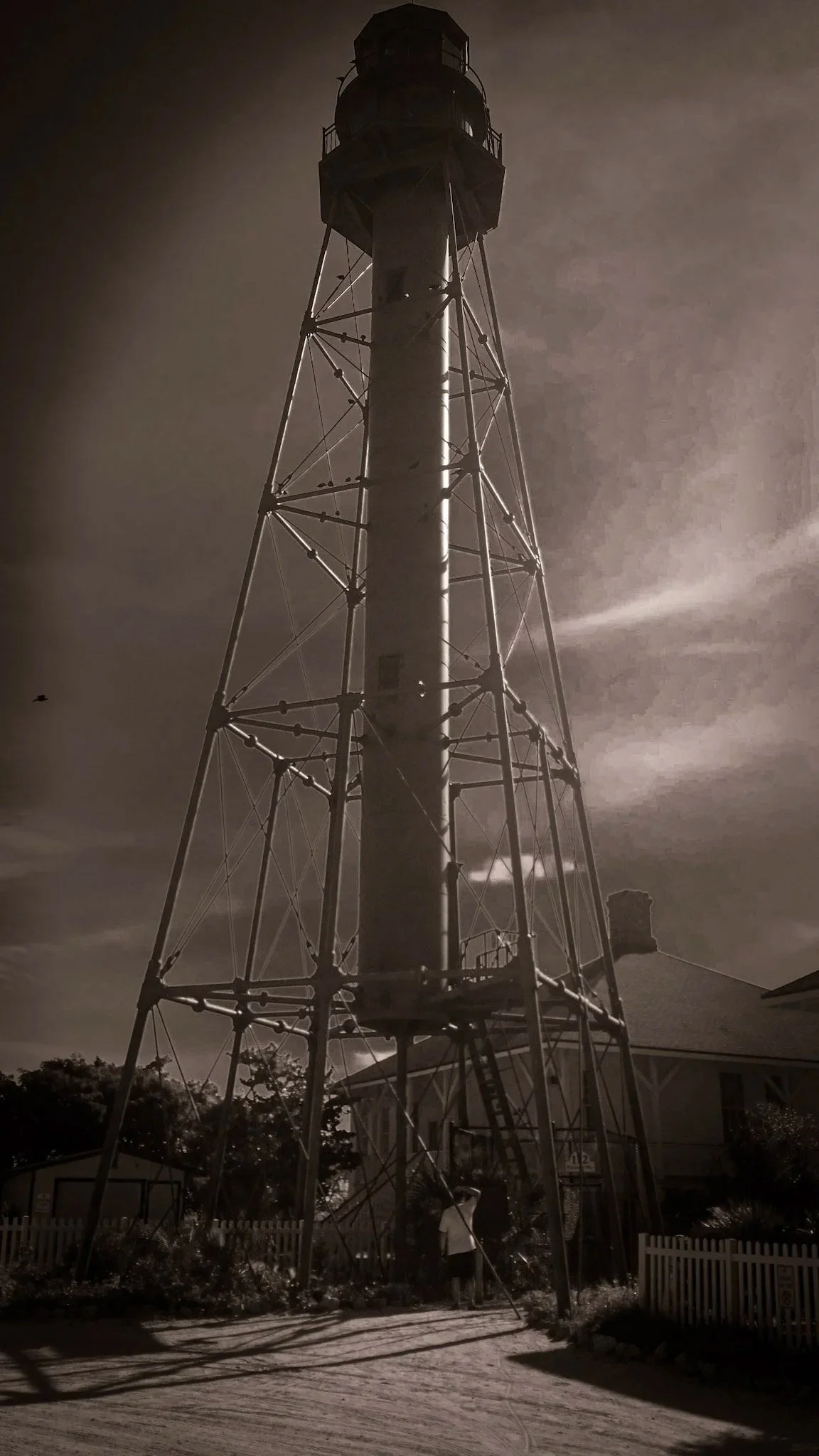 A sepia-toned monochrome image of the iconic Sanibel Lighthouse, symbolizing Glass Restoration Inc.'s commitment to preserving the coastal integrity and optical brilliance of barrier island properties.