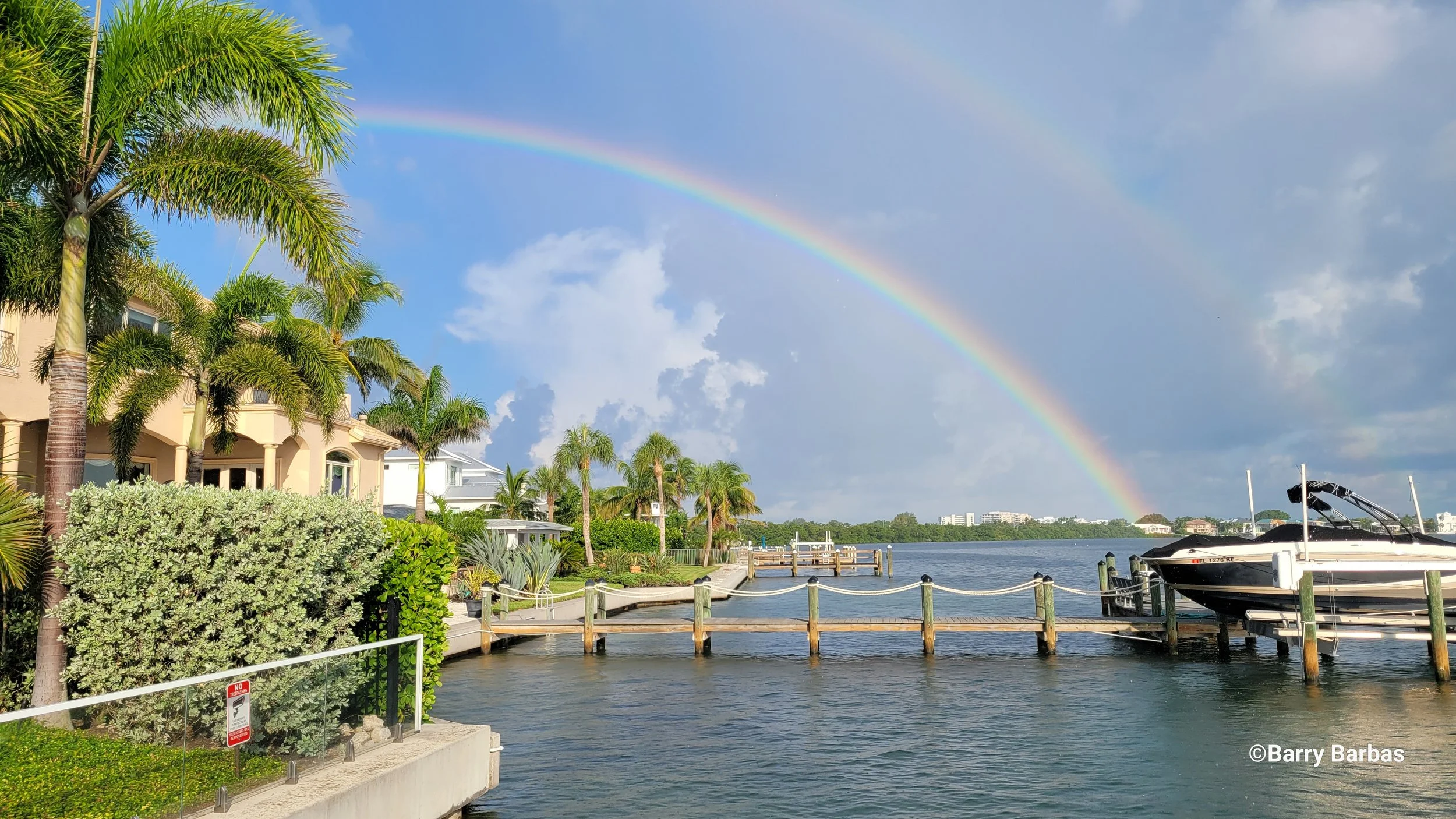 Waterfront homes with long docks on Sarasota Bay at The Inlets Bradenton FL — Glass Restoration Inc. serves canal front waterfront estates and boating community homes with professional glass scratch repair and glass polishing services