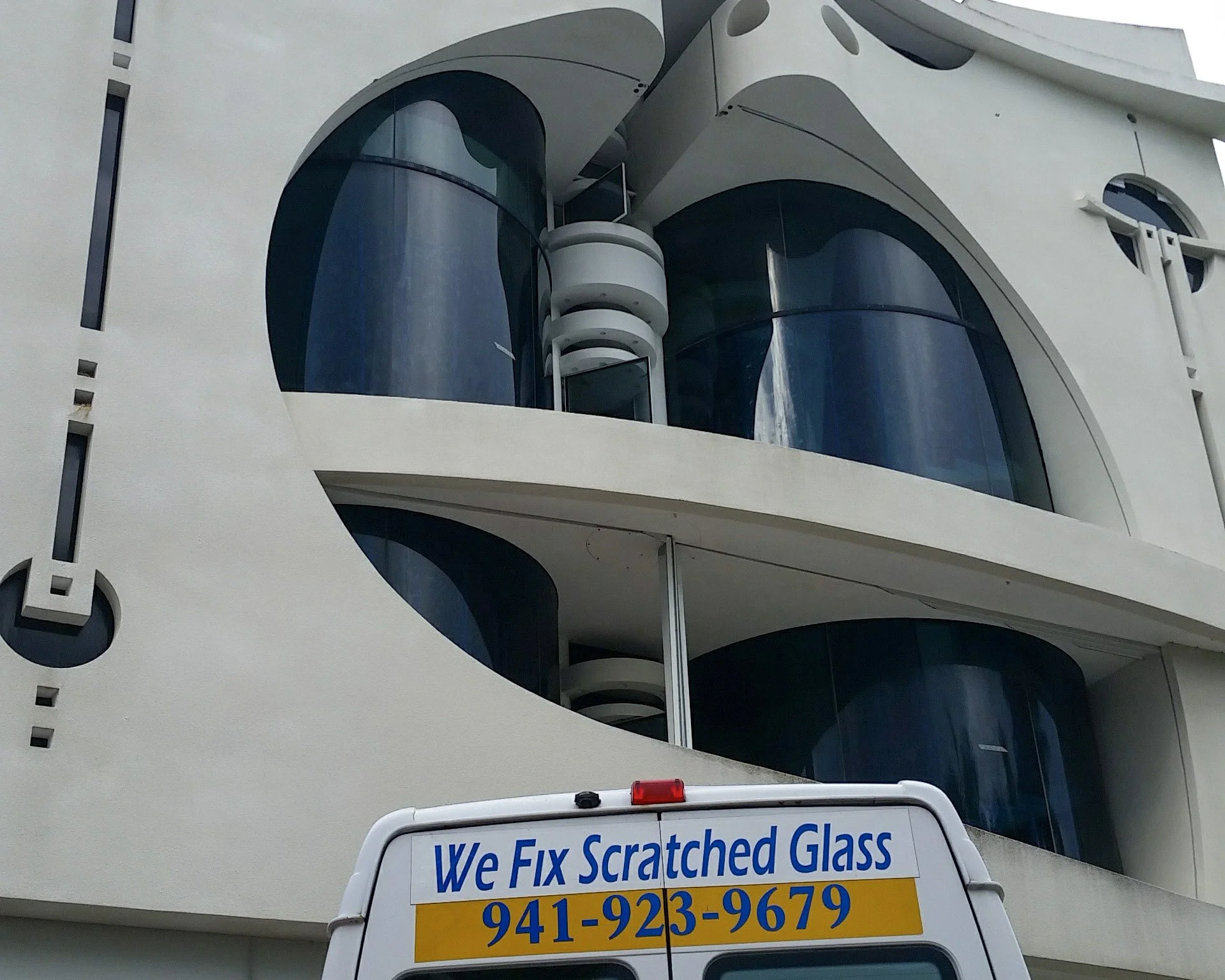 Glass Restoration Inc. on site at a curved glass architectural property in Florida — scratch repair and restoration specialists serving luxury homes and commercial buildings statewide.