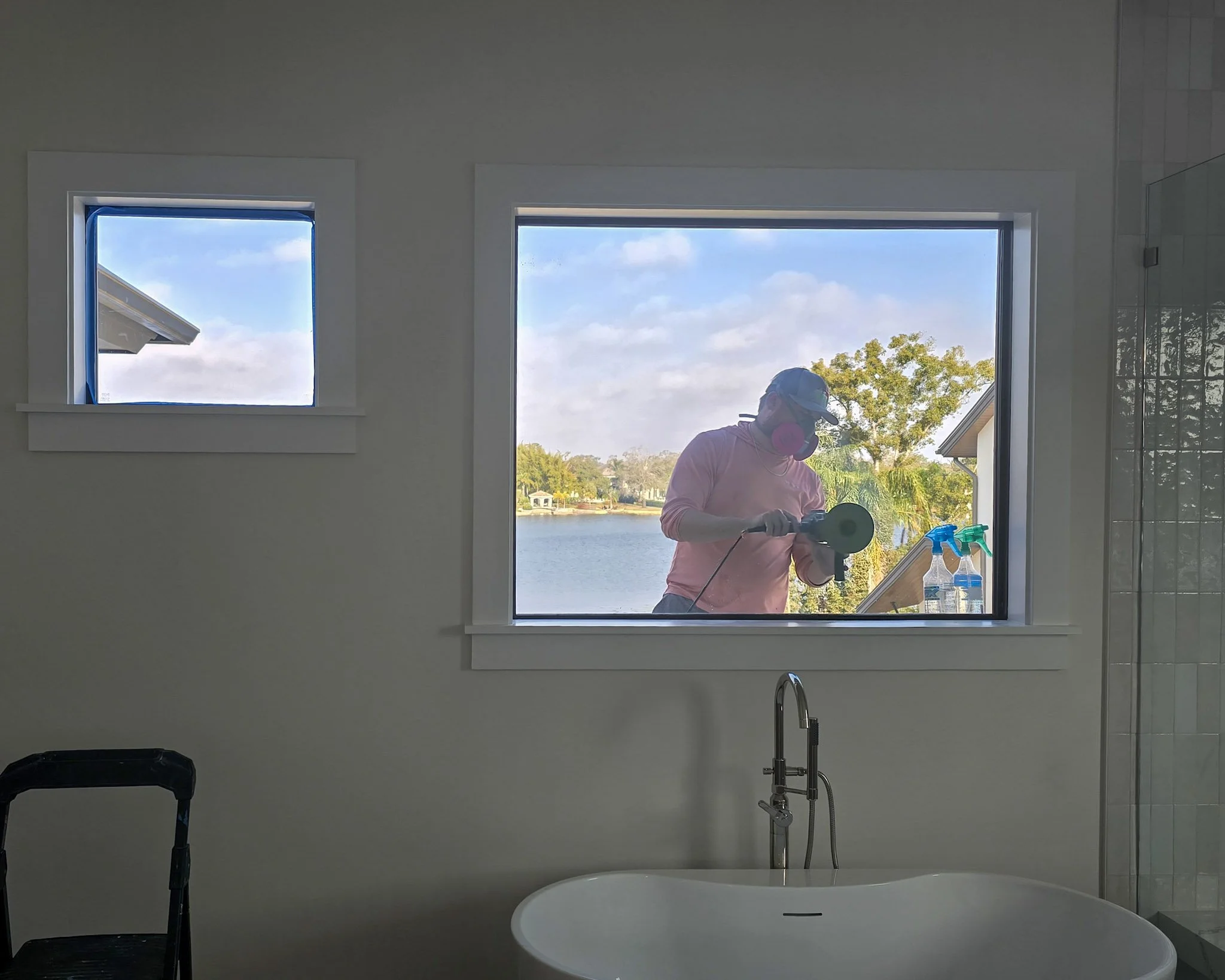 Repairing a tempered glass window in a waterside custom home.