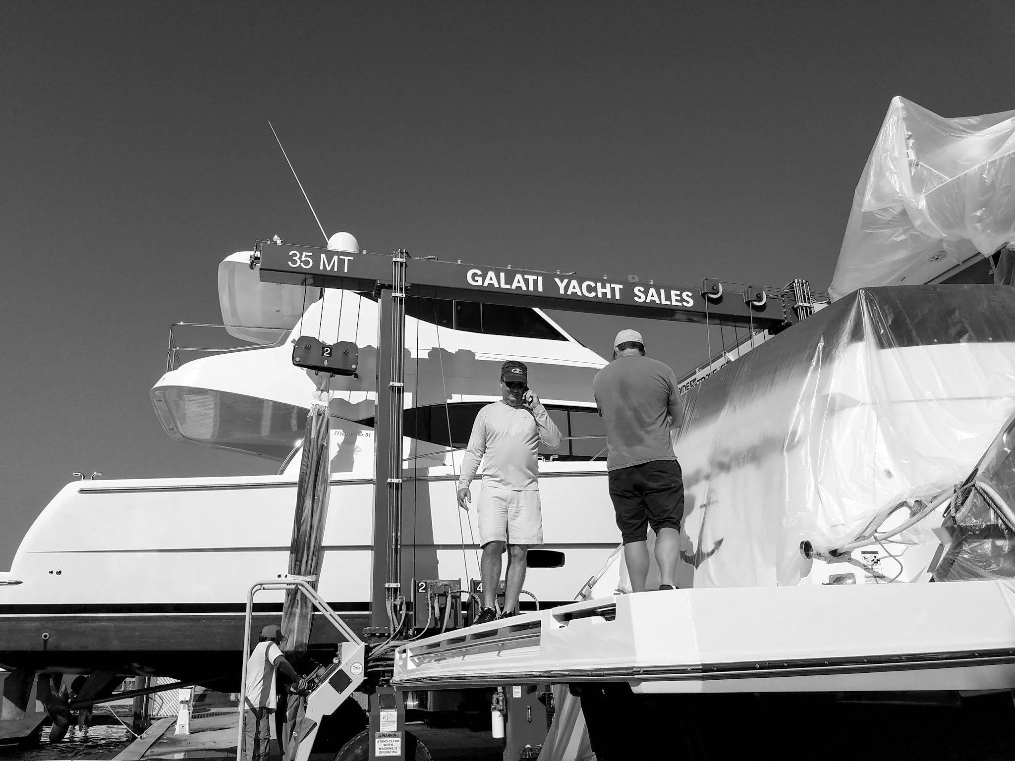 Glass Restoration Inc. technician Skyeler Schmidt performing marine glass restoration at Galati Yachts — professional on-site yacht and boat glass scratch repair serving North River Ranch Parrish and Manatee County
