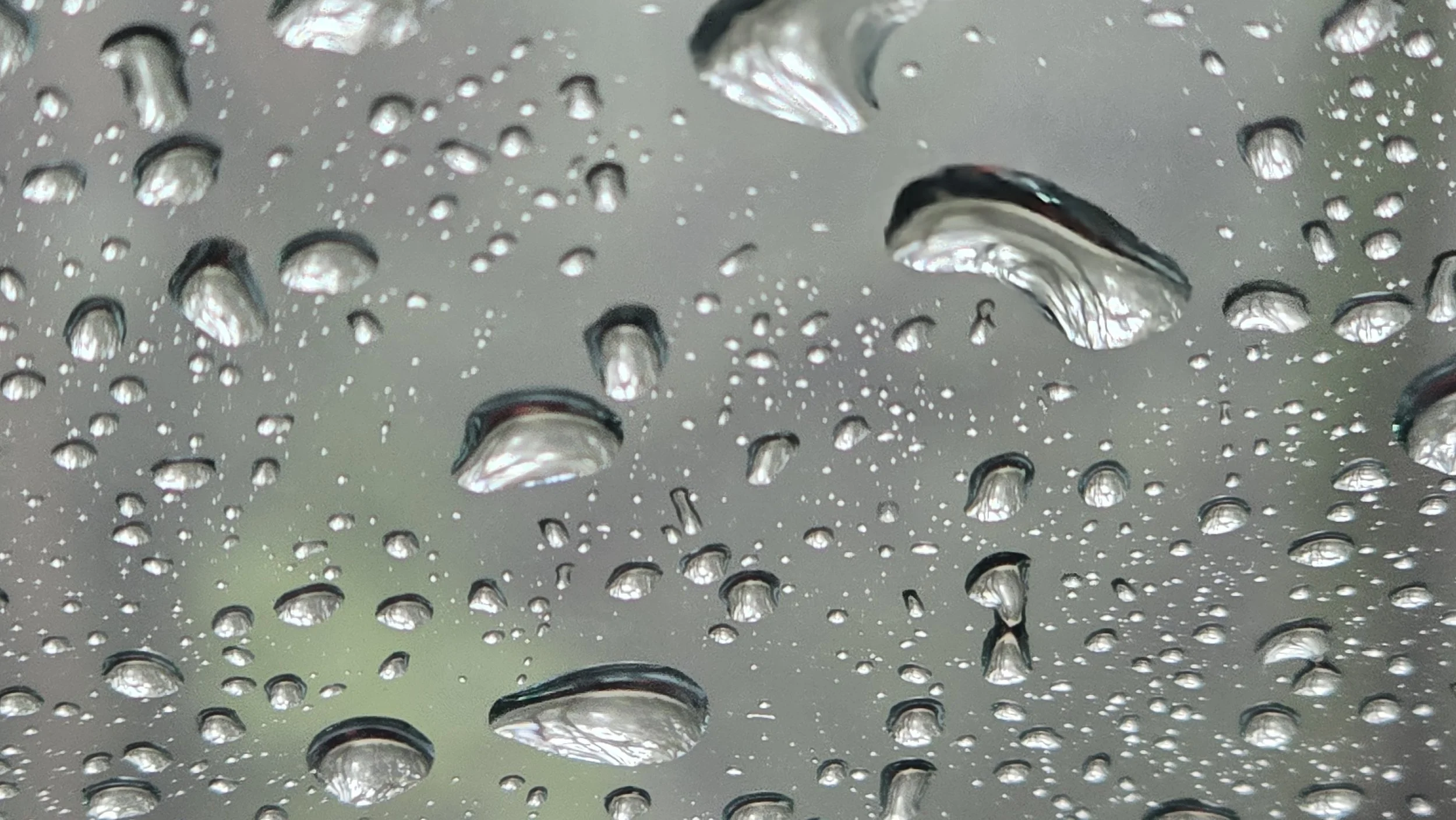 Hard water mineral deposits beginning to form on residential glass at The Lake Club Lakewood Ranch FL — lake irrigation overspray bonds to glass surfaces under Florida UV exposure requiring professional glass polishing services