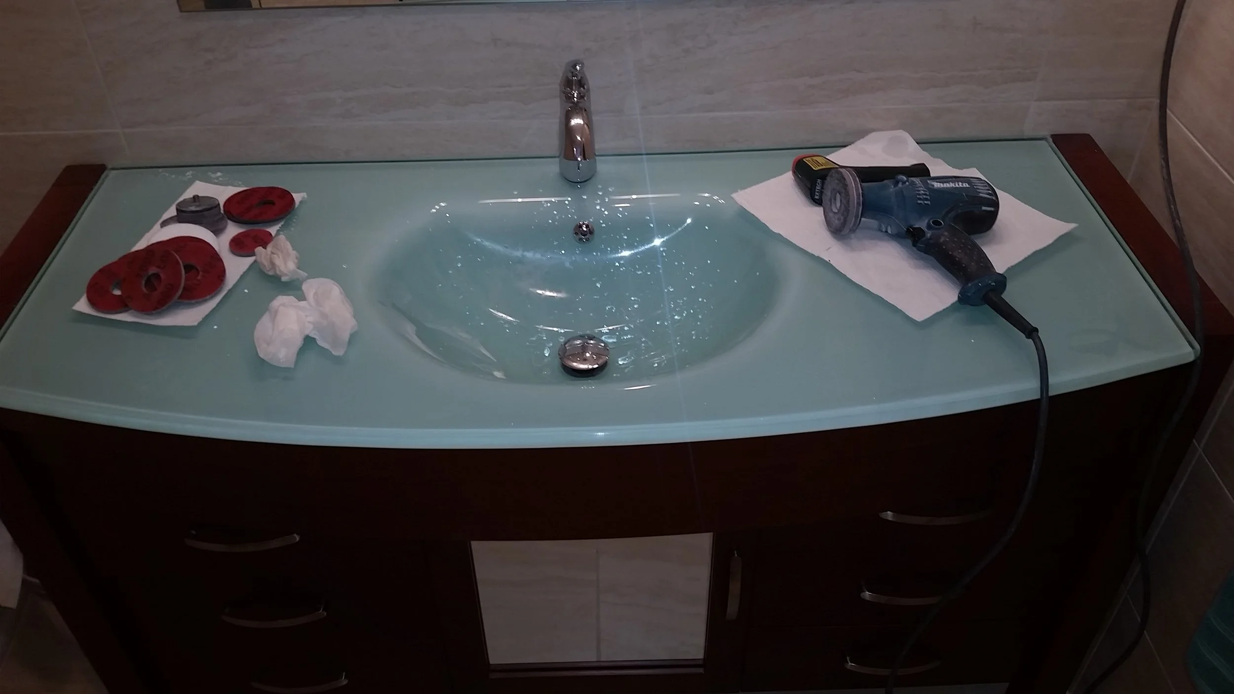 Glass vanity top scratched during build. We repaired the glass and polished out the scratch. Before and After