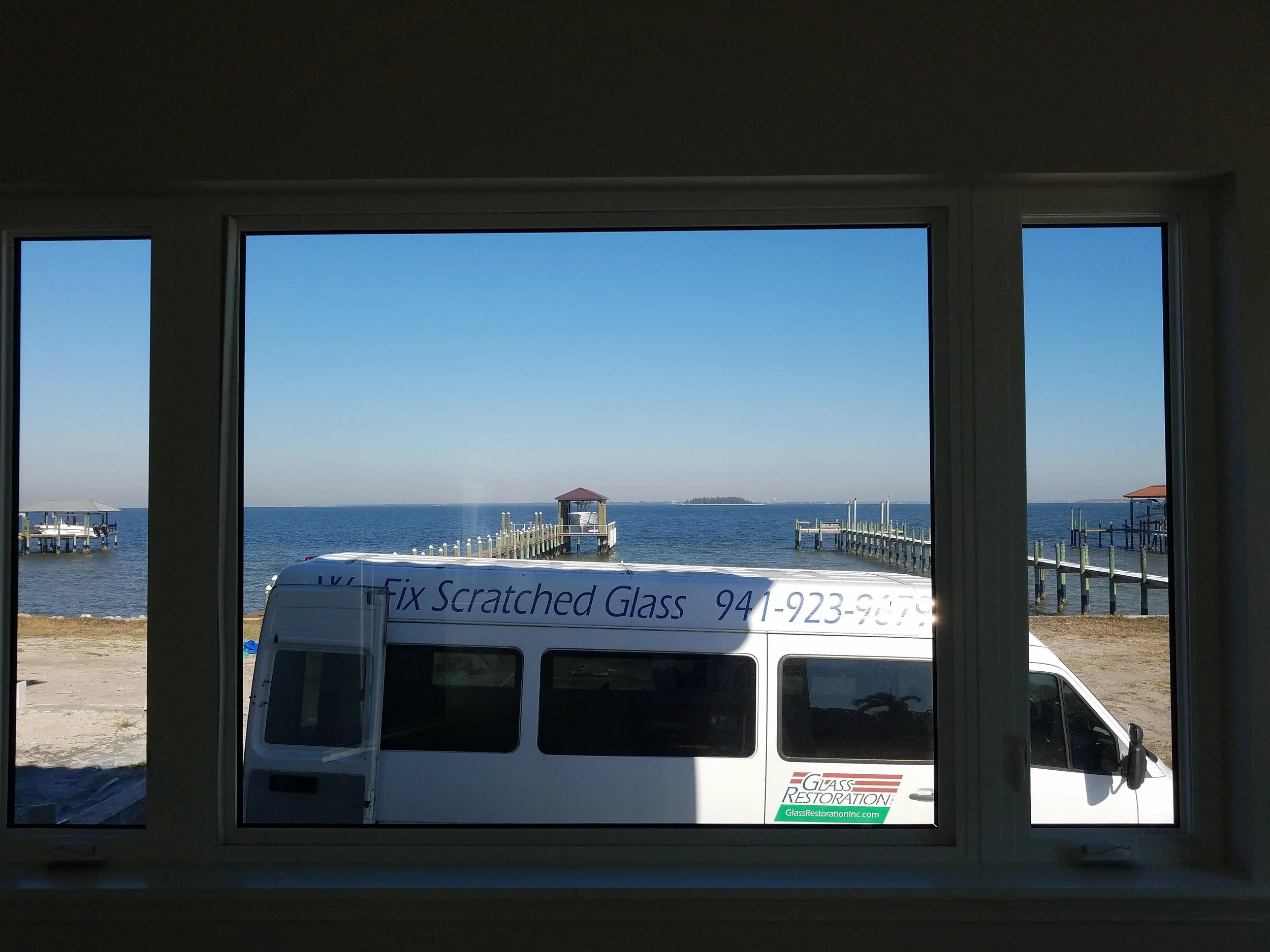 Impact glass bay view window restored on Terra Ceia Island waterfront home — Glass Restoration Inc. artisan scratch removal specialists serving Manatee County