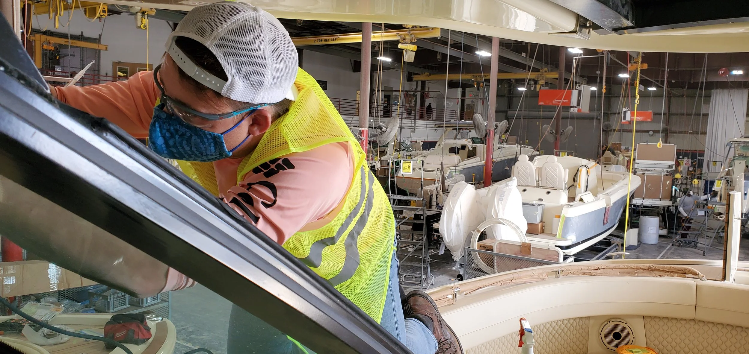 Skyeler Schmidt of Glass Restoration Inc. working on boat glass inside the Chris-Craft manufacturing facility in Sarasota FL — one of dozens of verified factory glass restoration jobs completed at the iconic American boat builder