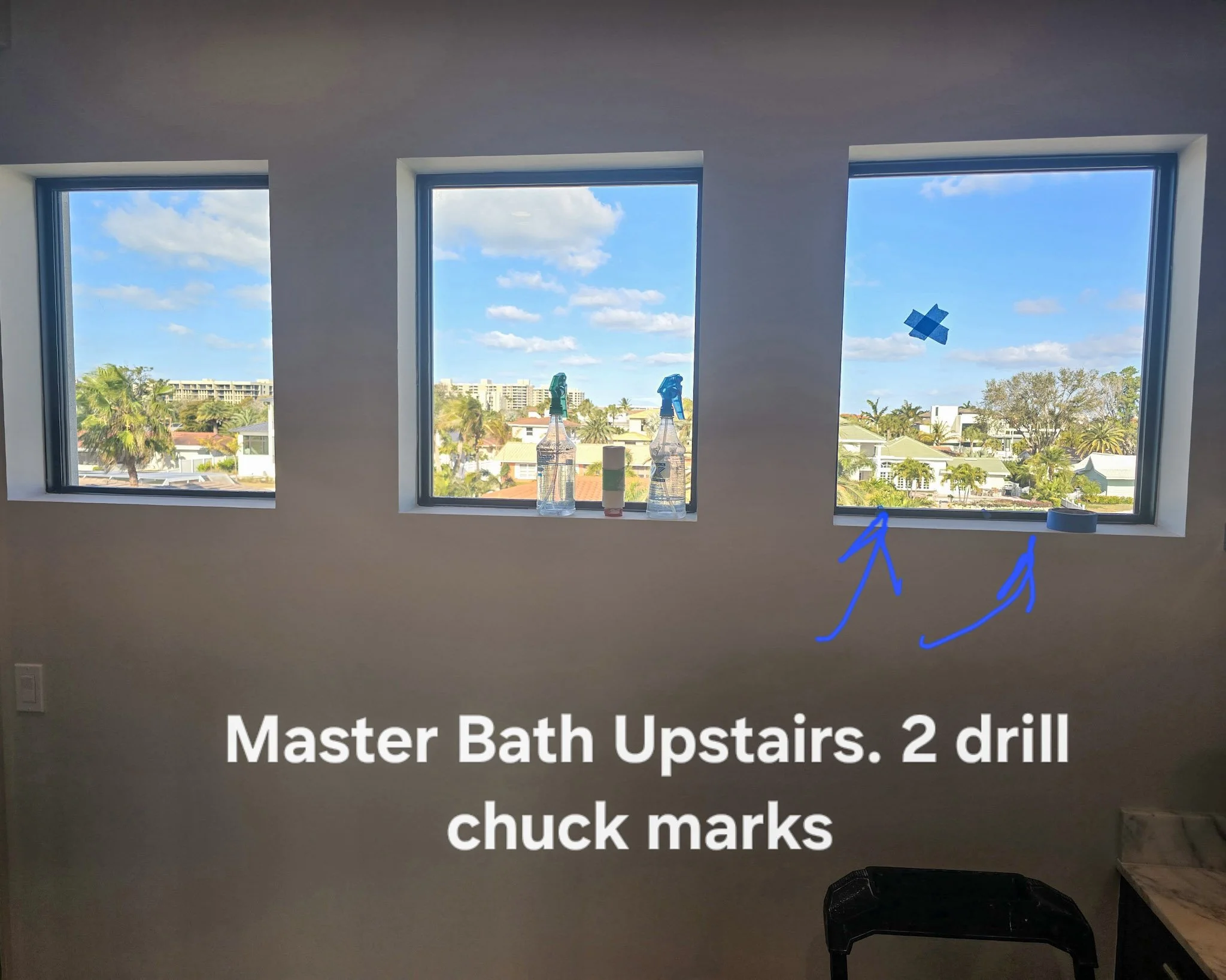 Master bathroom window glass with drill chuck marks identified — a common construction damage issue Glass Restoration Inc. resolves on-site for builders at Creeks Edge Parrish FL