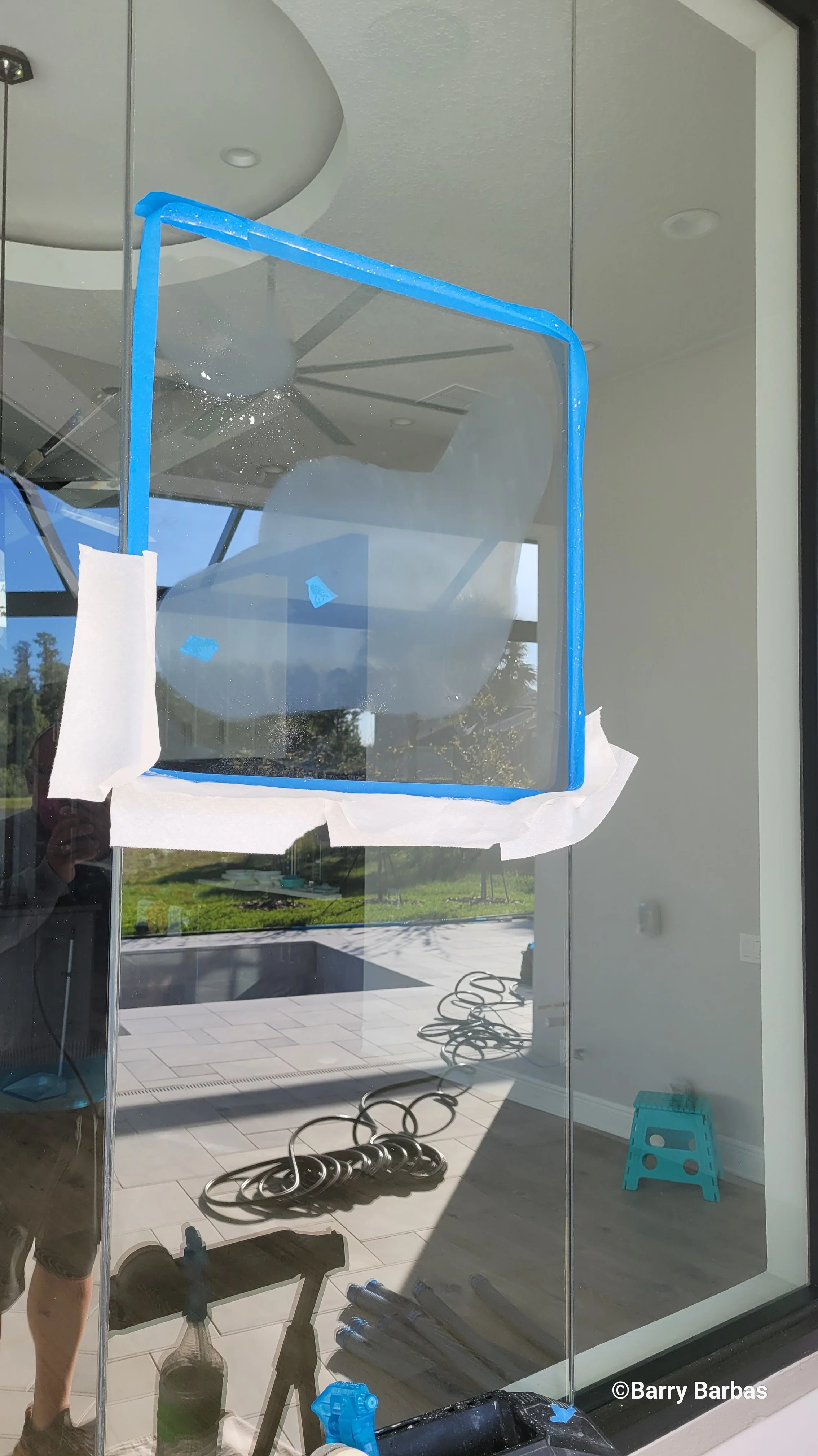 Artisan glass preservation on a seamless, aquarium-style butt-jointed glass radius wall in Plant City. The frame-free design relies on precision clear silicone attachments to maintain a continuous, all-glass aesthetic