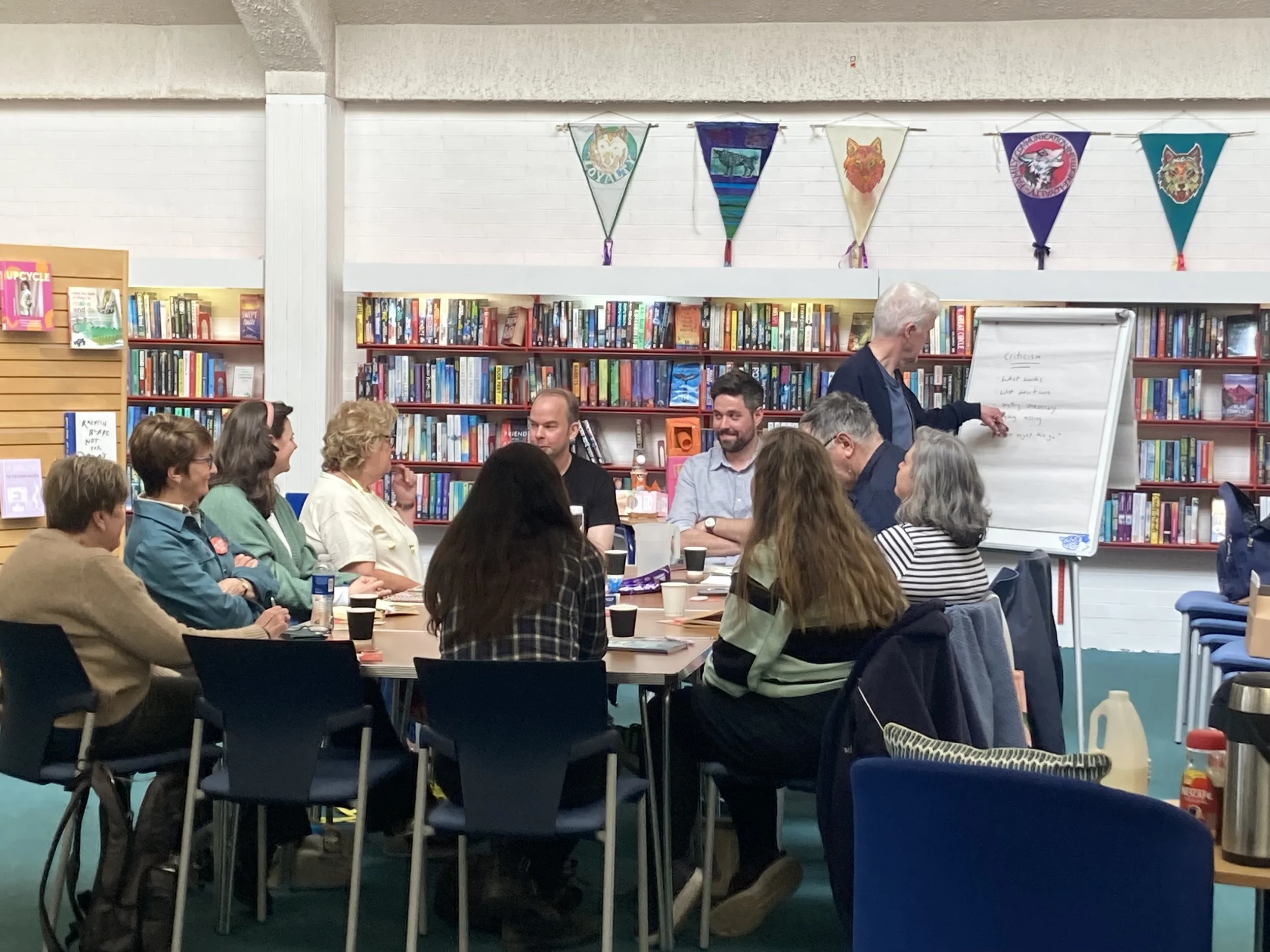 Writers round the table sharing their work with one another