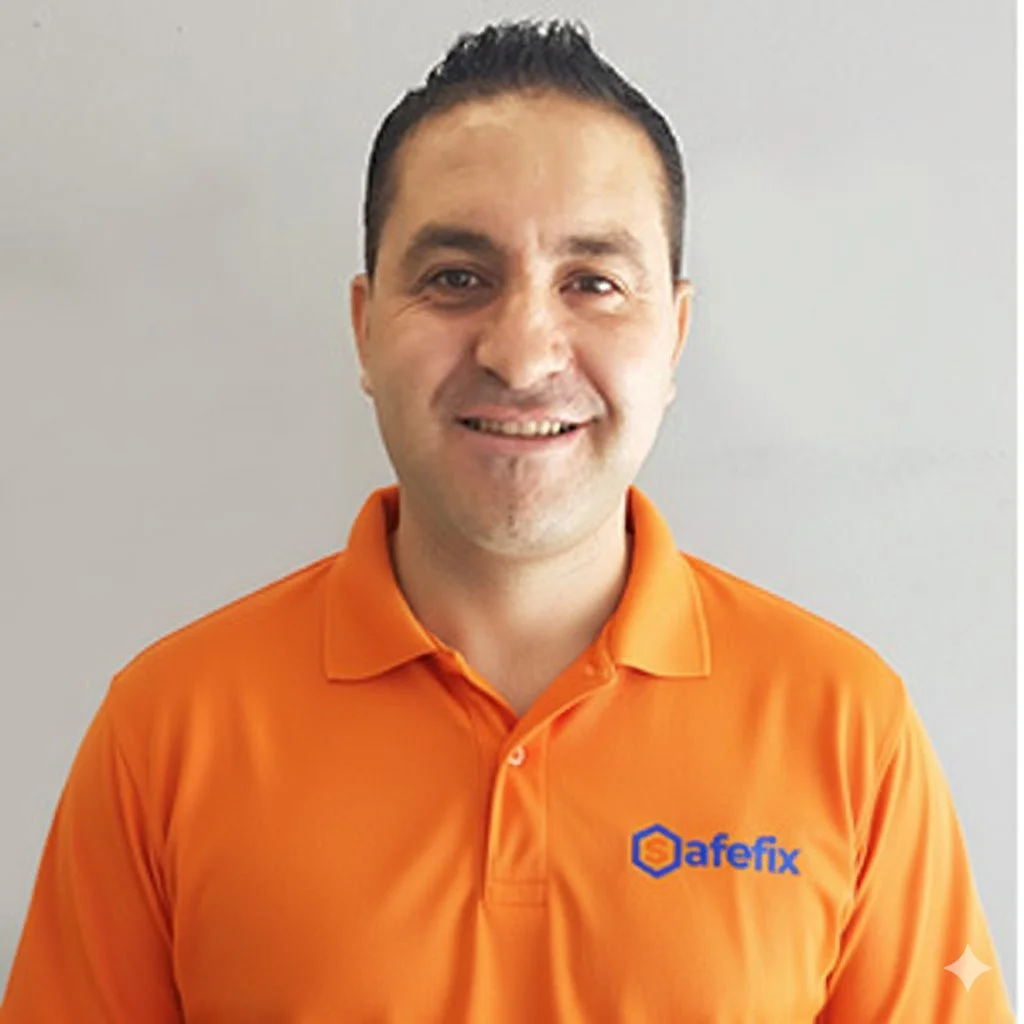 Person wearing a black polo shirt with "SAYFYARD" and a phone number embroidered on the chest, standing against a neutral background.