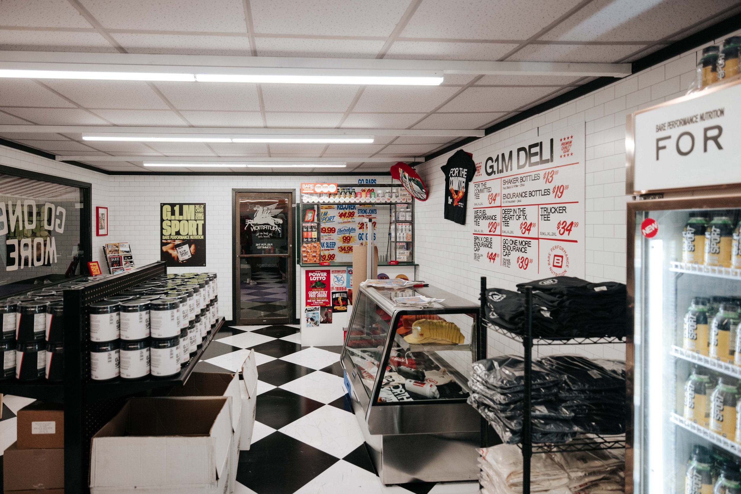 Interior of the Fuel Station. Designed to look like a 1980s New York City bodega with custom flooring, a "merch deli", and convenience check out that had a custom functioning lottery game, and Zyn inspired electrolyte pouches (fake product).