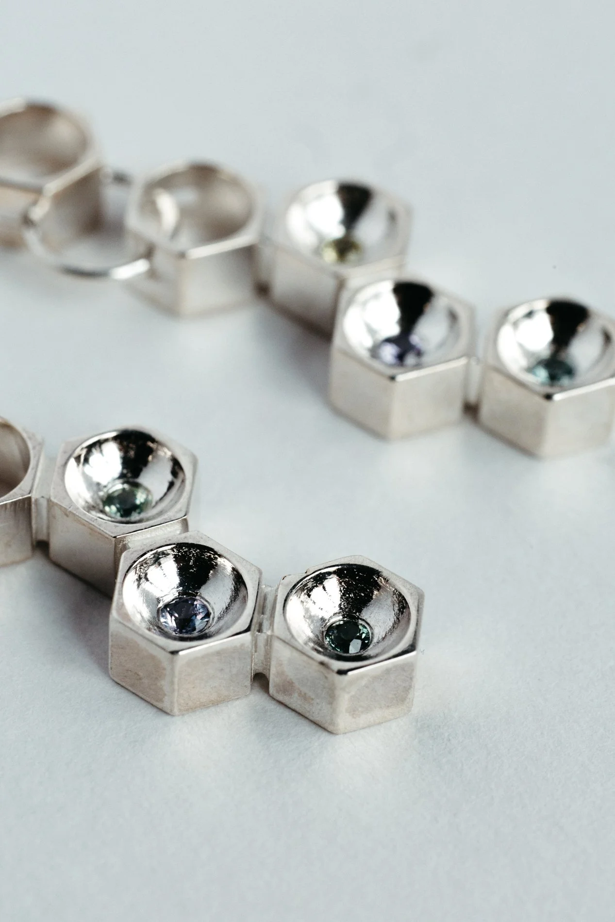 Particles family long earrings V1.2 by Sajfrt — handcrafted in Belgium with silver or gold, and stones including sapphires, diamonds, and tourmalines.