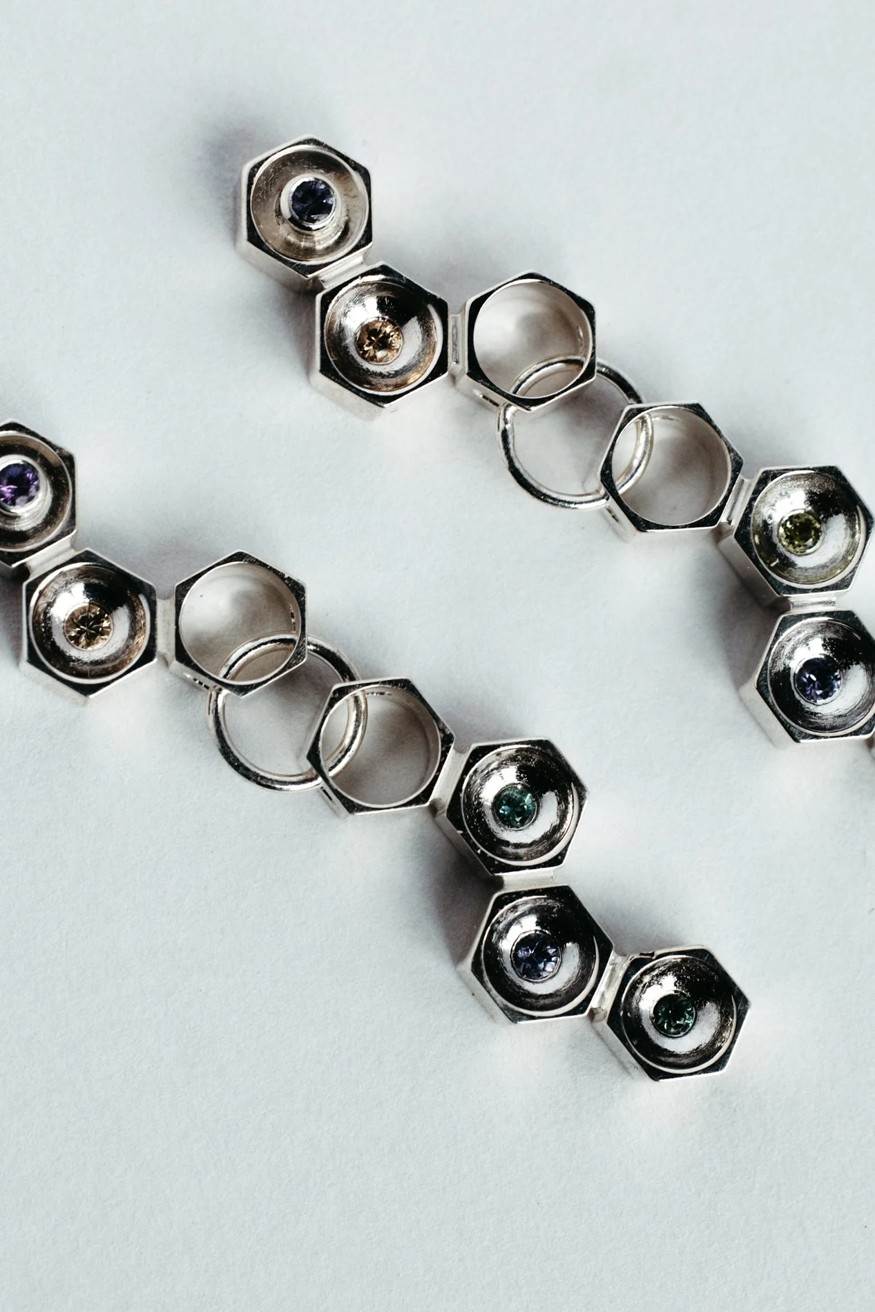 Particles family long earrings V1.2 by Sajfrt — handcrafted in Belgium with silver or gold, and stones including sapphires, diamonds, and tourmalines.