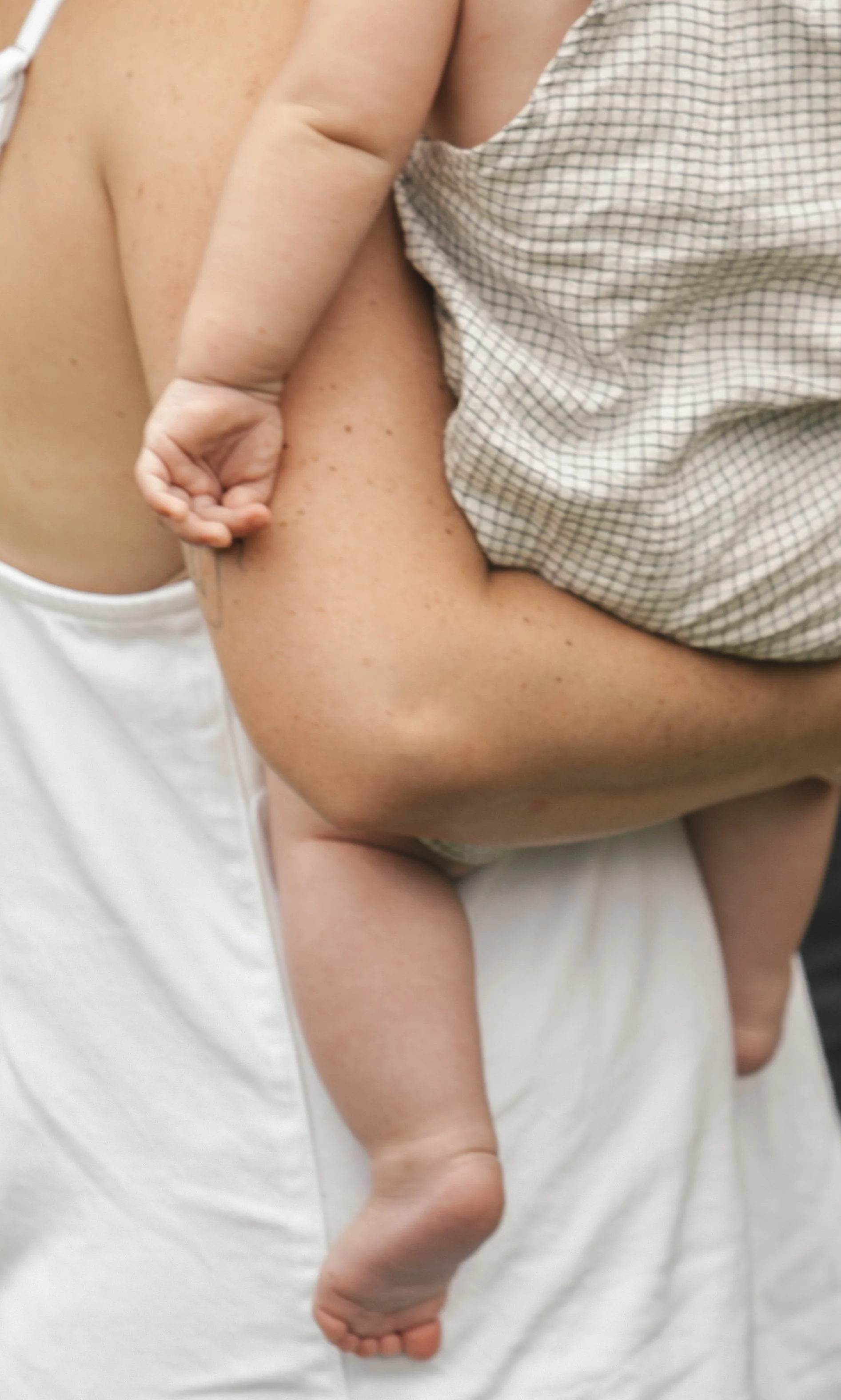 Carrying a baby on your hip while completing tasks because the baby desires connection from a caregiver. Exhaustion is bone deep but a mother's love is deeper.