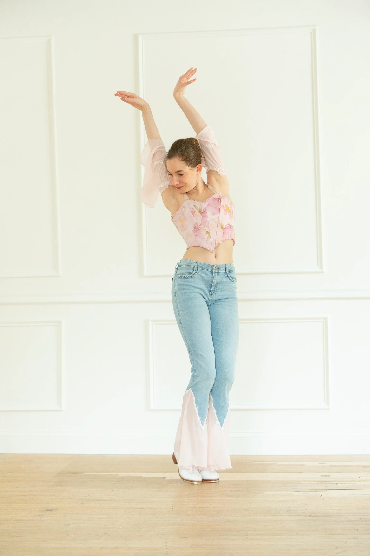 Tap model showcasing her custom designed costume that includes flutter sleeves that are off the shoulder, and a fitted basque style bodice designed by Le Chaton Tutus. 