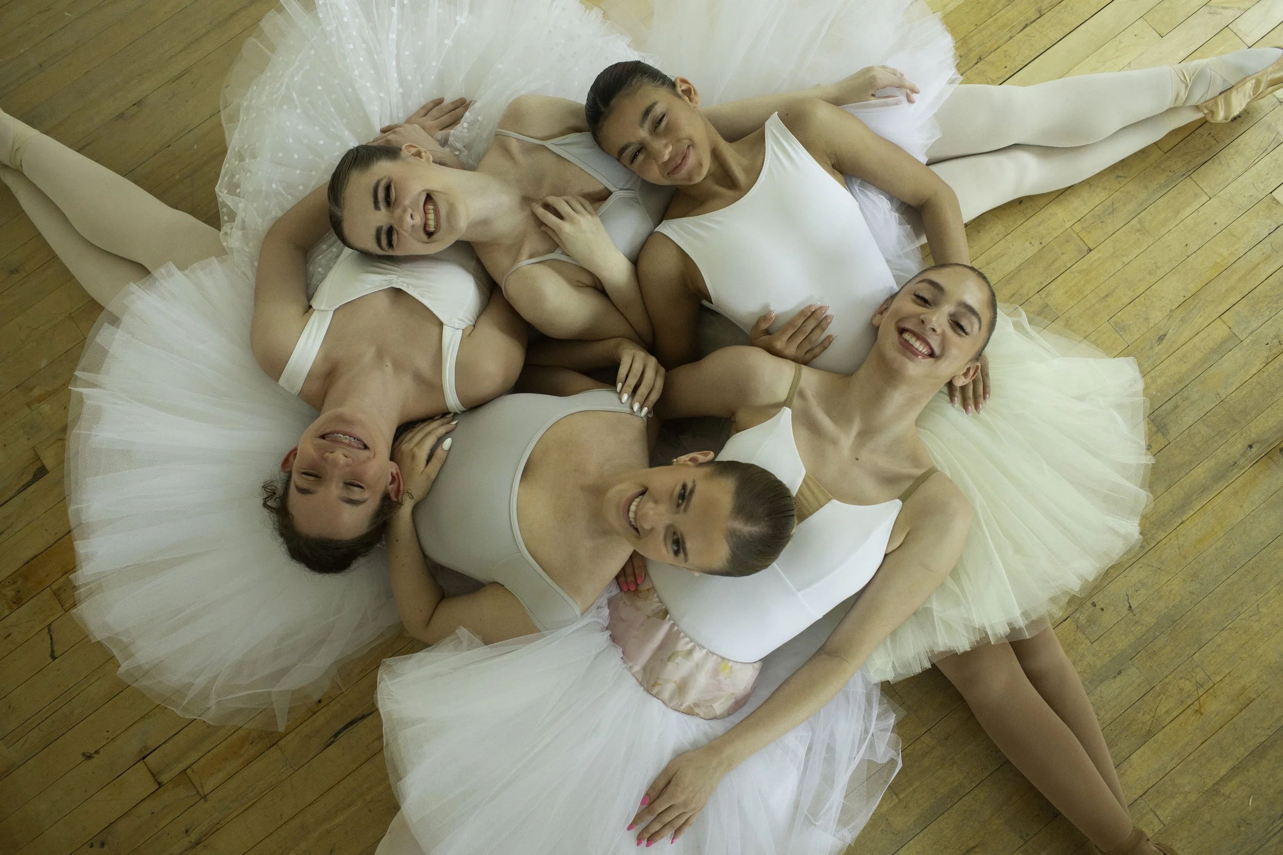Ballerinas laughing while wear Le Chaton practice tutus.