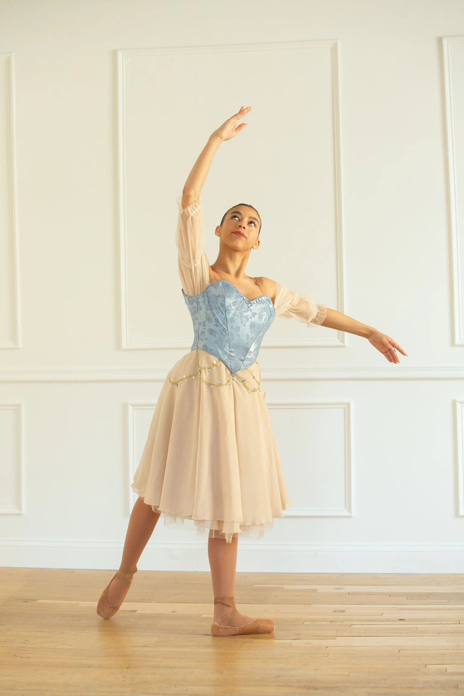 A ballet student wearing her custom designed and custom fitted professional ballet costume worn at ballet competitions. 
