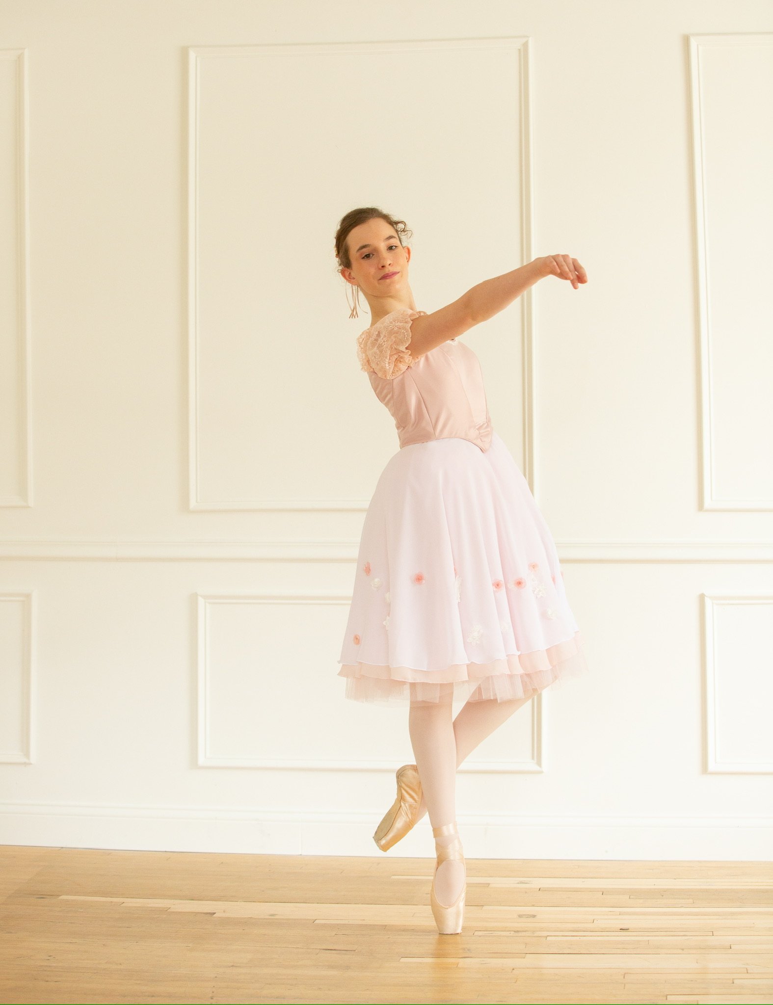 Ballet student wearing her professional ballet romantic tutu costume worn at ballet competitions. 