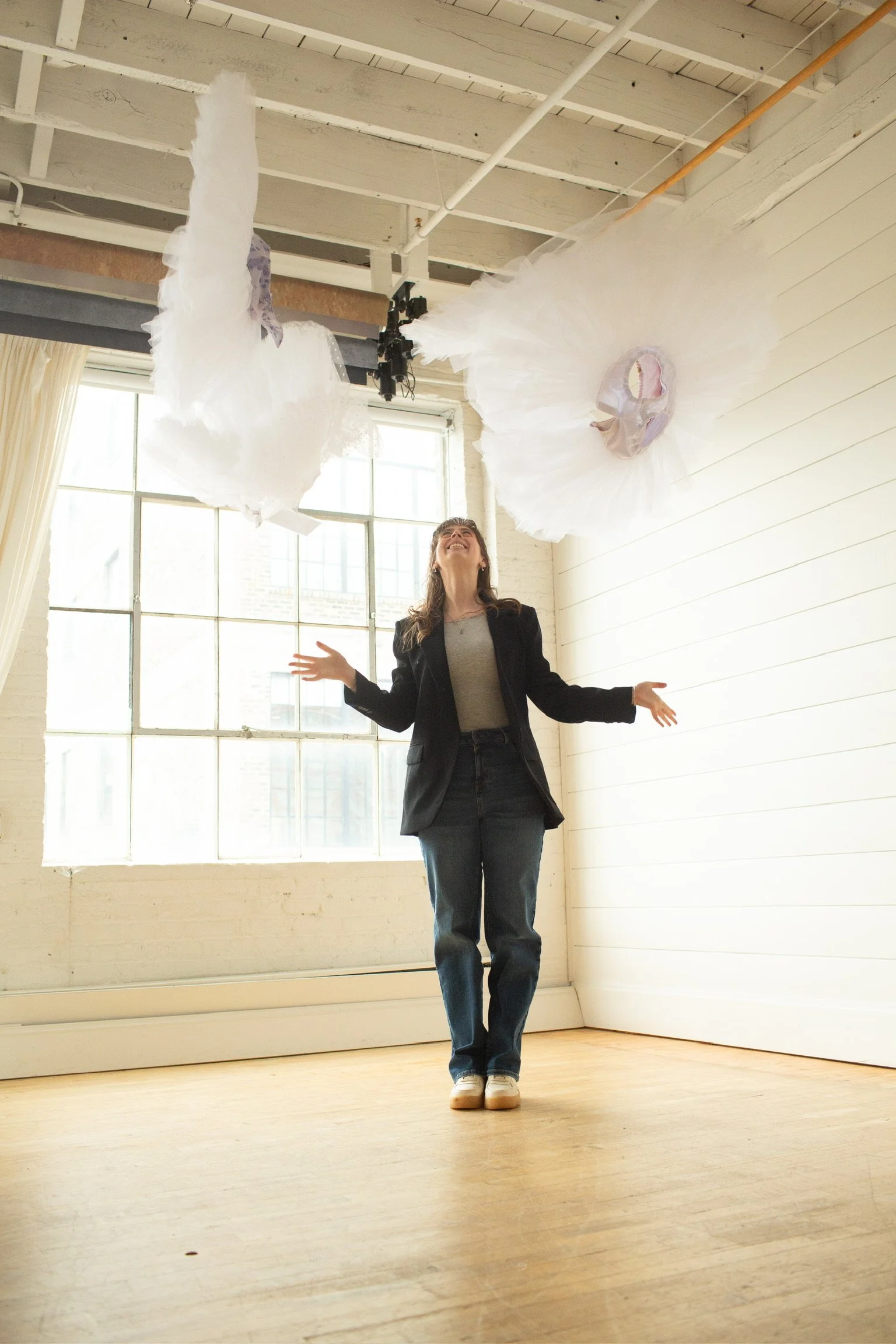 Founder and owner of Le Chaton Tutus throwing a bunch of practice tutus.