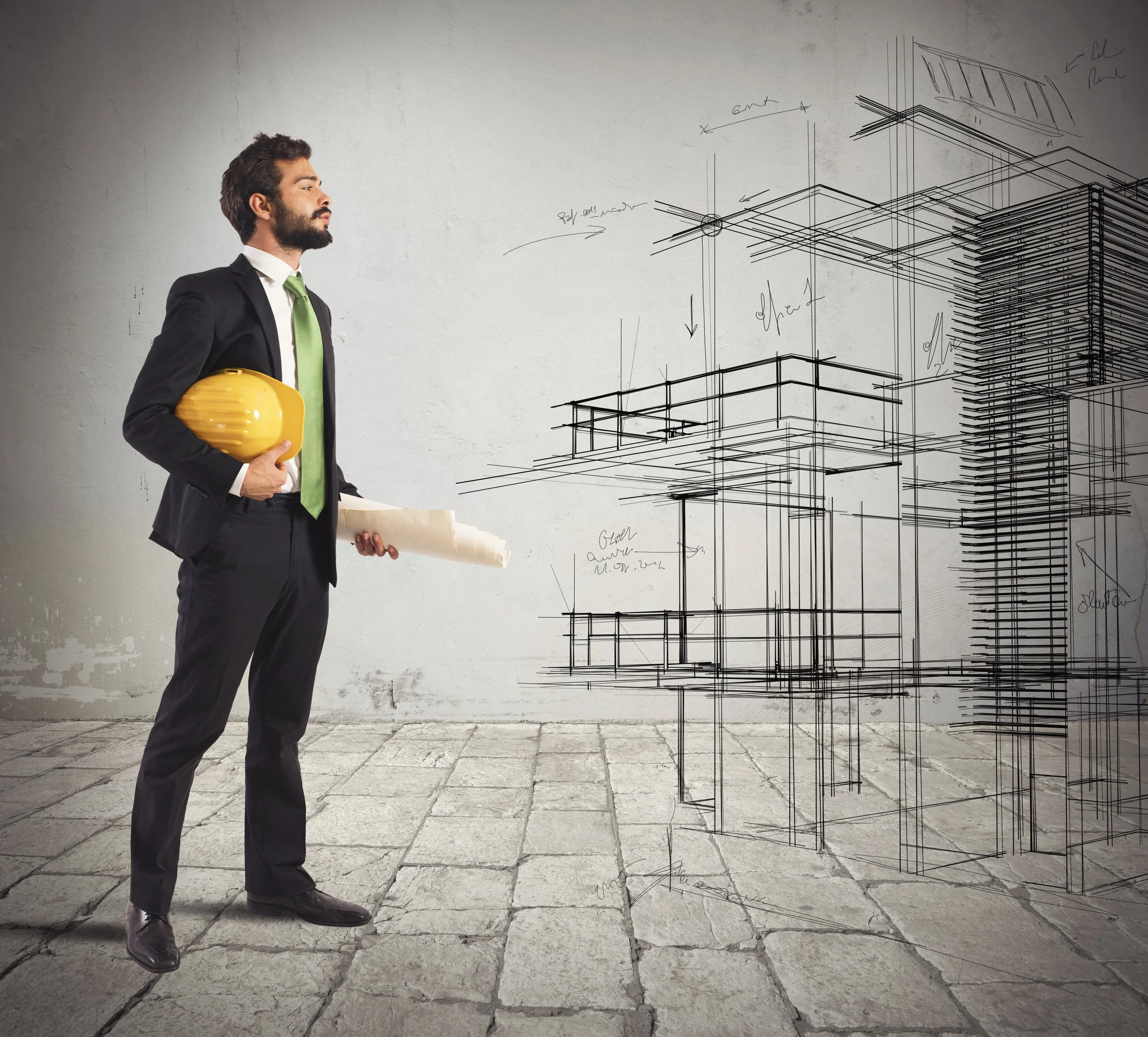 A man in a suit holding a yellow hard hat and a rolled blueprint, standing in front of a wall with an architectural drawing of a building.