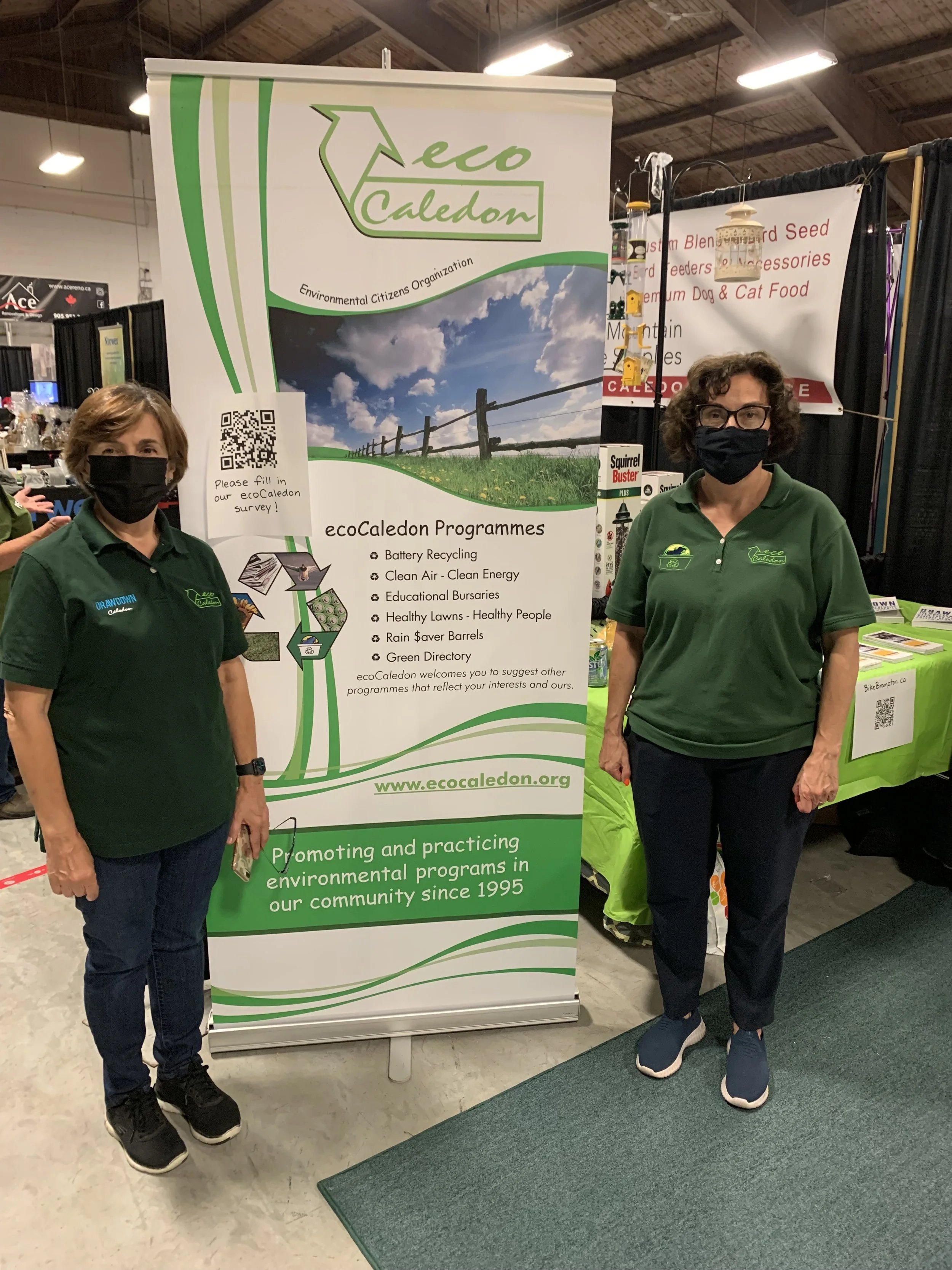 ecoCaledon volunteers standing in front of an ecoCaledon banner at an event