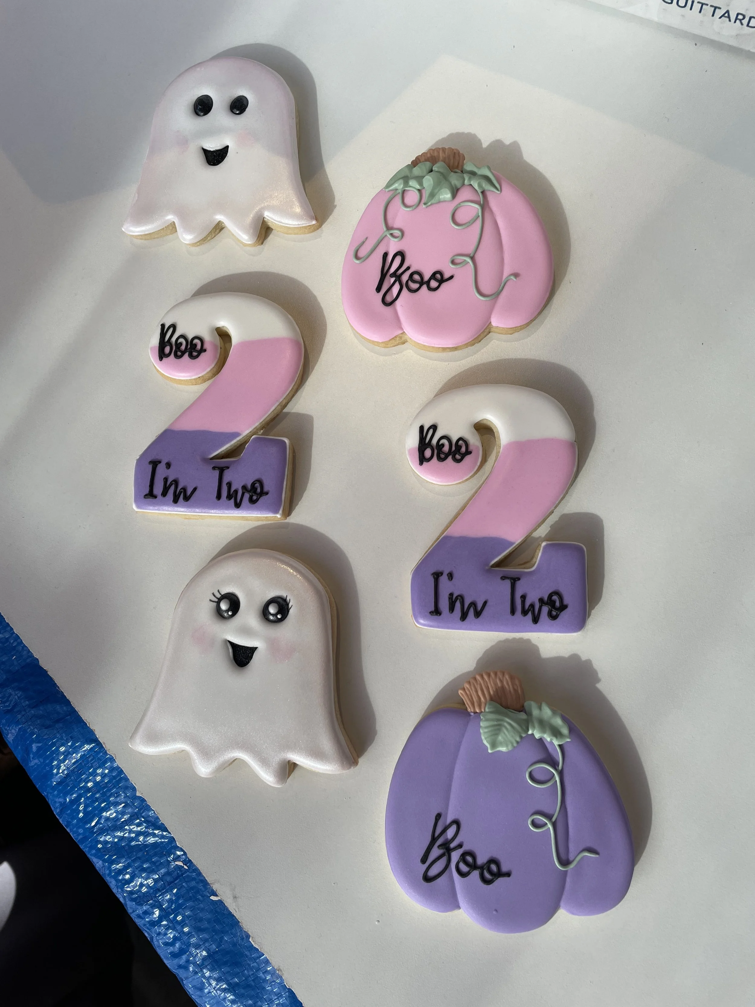 Decorated cookies with Halloween and birthday themes, featuring ghosts, pumpkins, and numbered decorations that say "I'm Two" and "Boo".