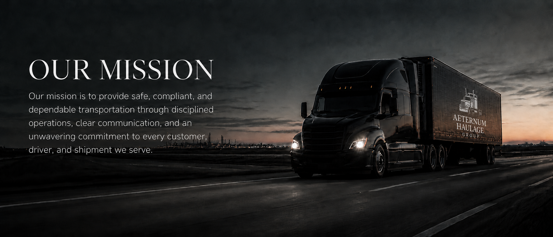 A black semi-truck driving on an empty highway during sunset with the city skyline in the distance. The truck has the logo of Aternum Haulage Group on its trailer.
