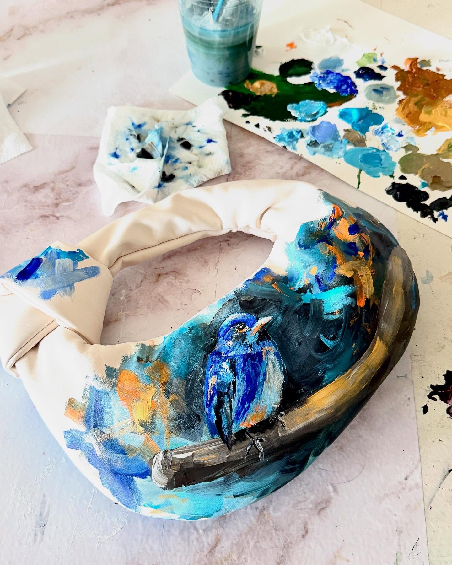 Took a little break from working with veneer and cyanotypes to create this hand-painted clutch for a night out at the zoo! 🎨🐦 Swipe to see both sides &mdash; one features a bold bluebird, the other a sweeping crane in vibrant brushstrokes. It was s