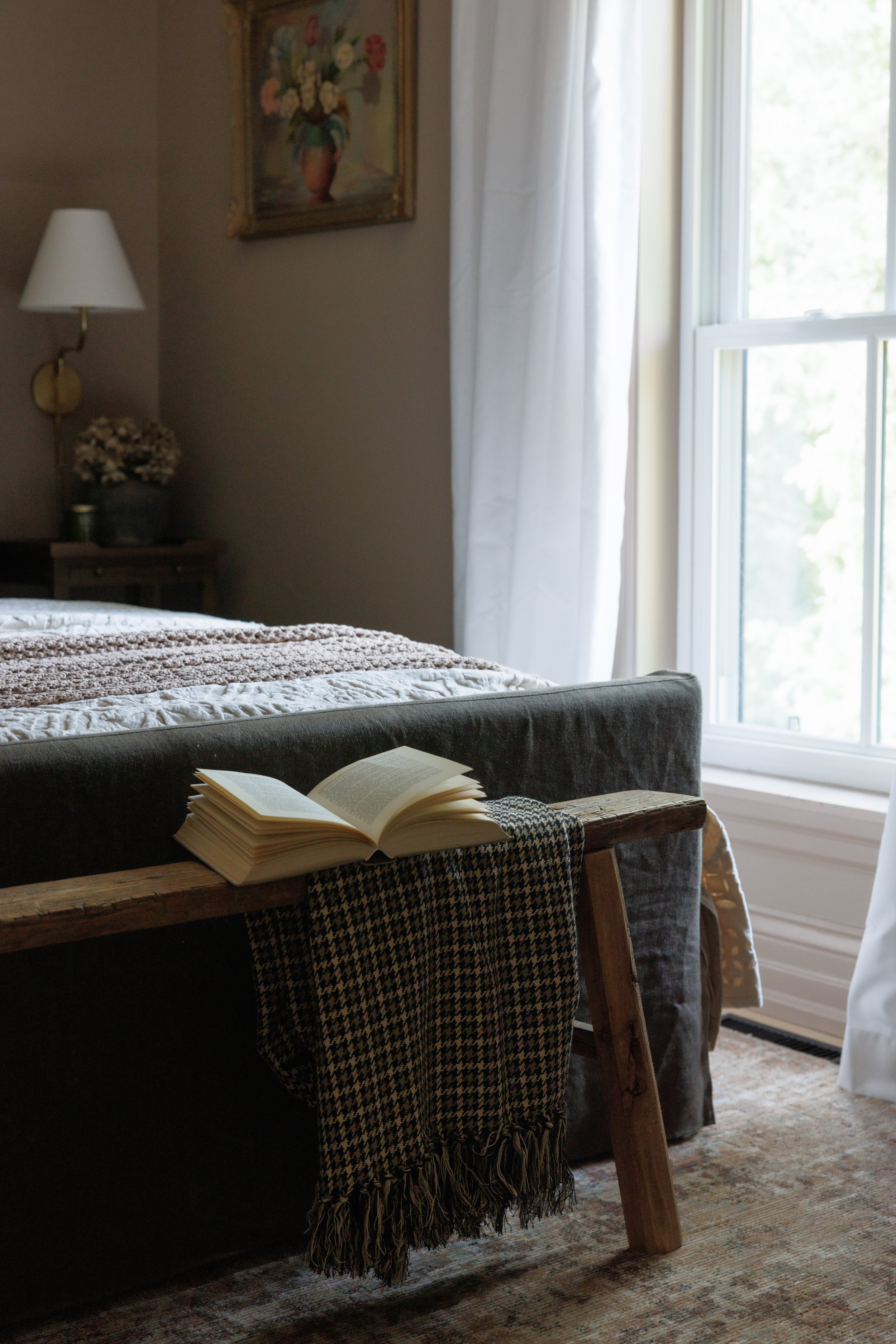 Warm, moody guest space featuring vintage accents and textural bedding