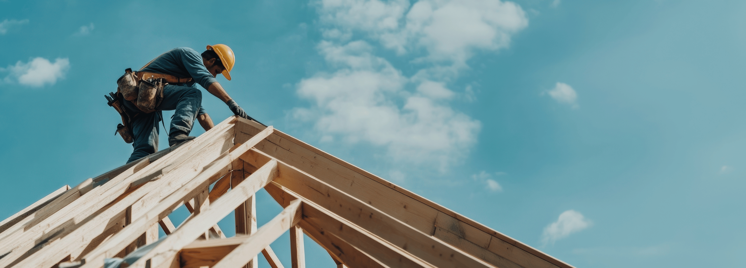 Builder standing on timber roof on construction site