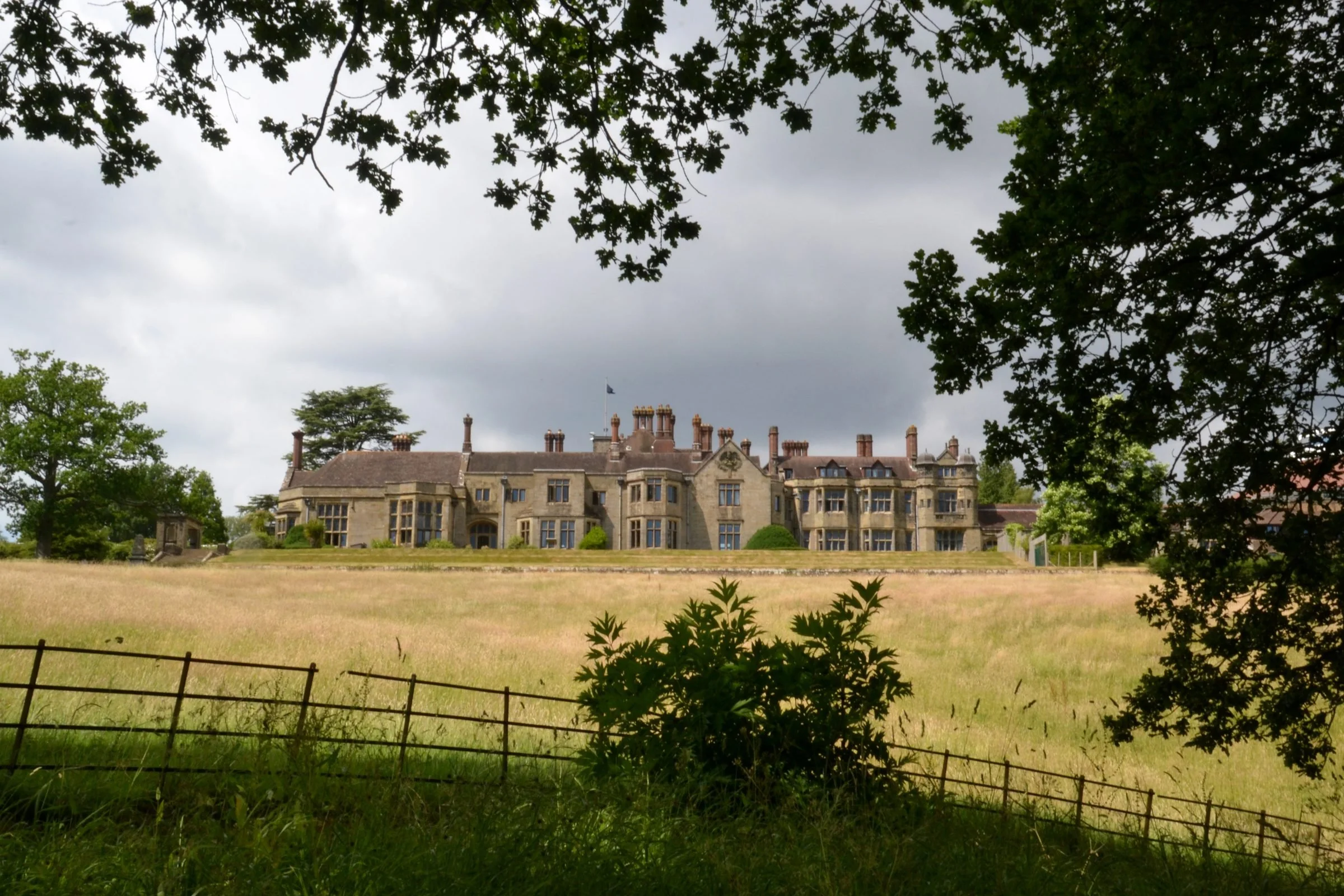 Worth Abbey seen across parkland grassland in the High Weald, Mid Sussex