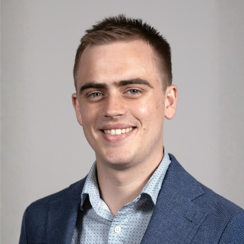 Smiling person with suit and short hair