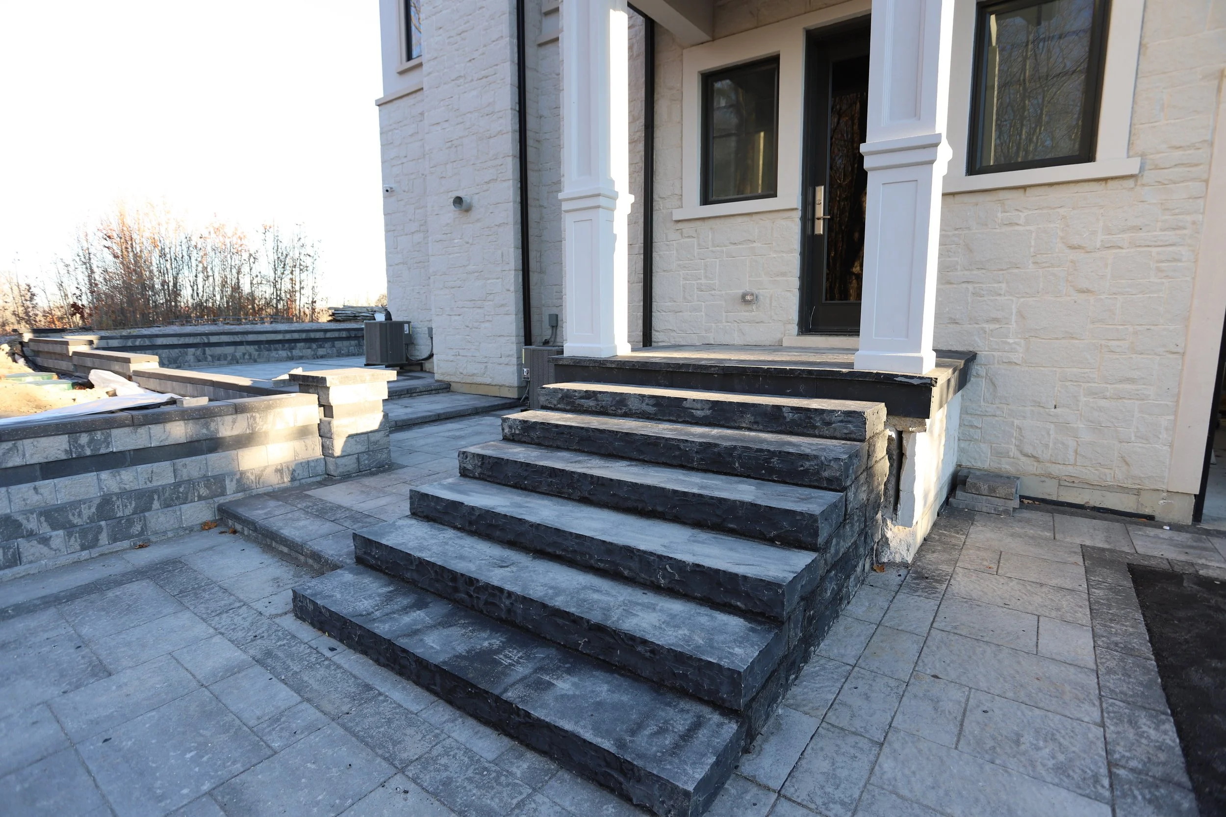 Stone steps and columns outside a house