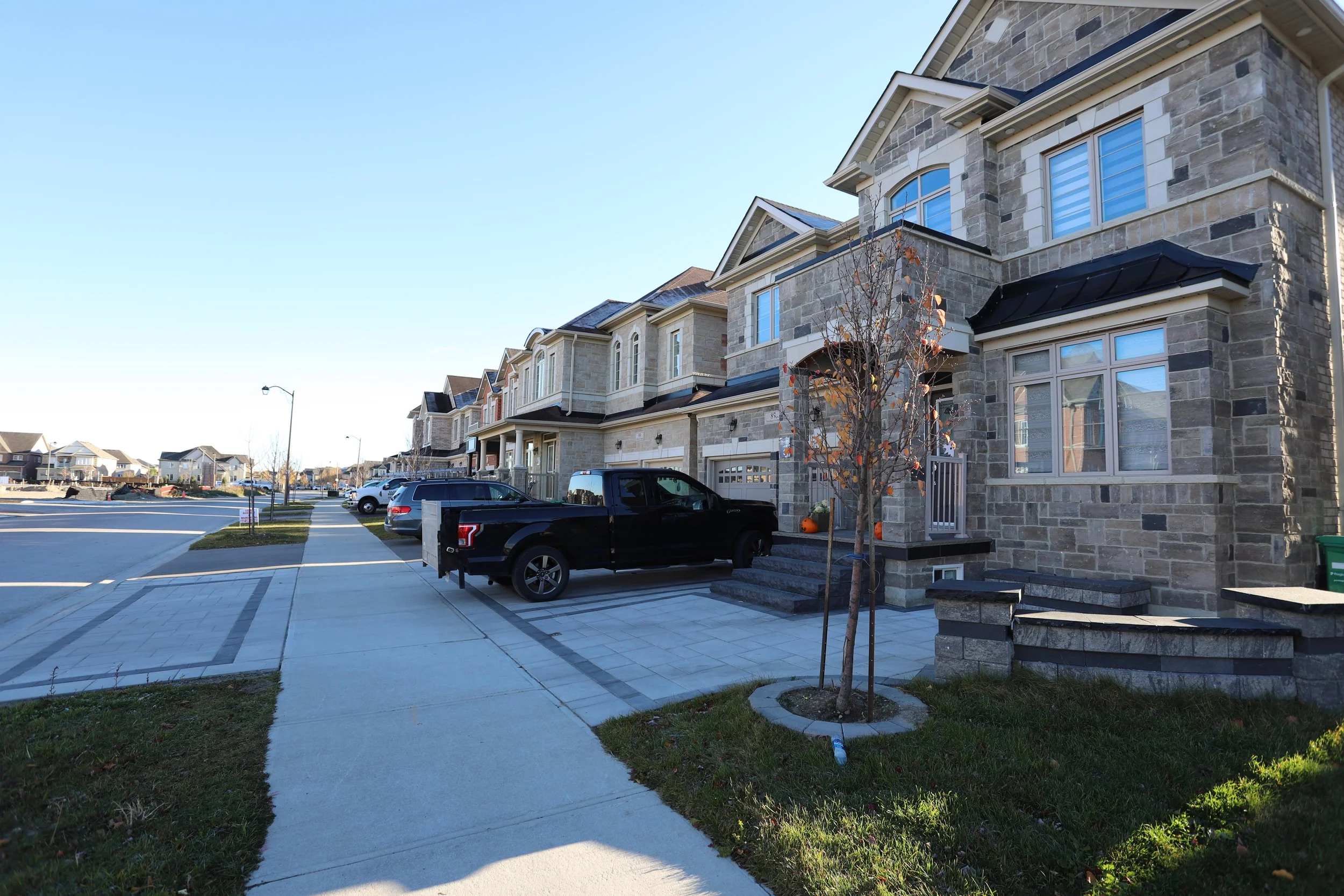 Suburban street with townhouses and parked cars