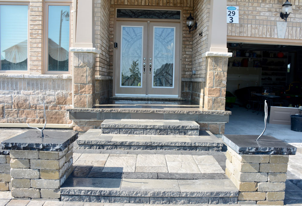 Stone front porch with double doors and garage
