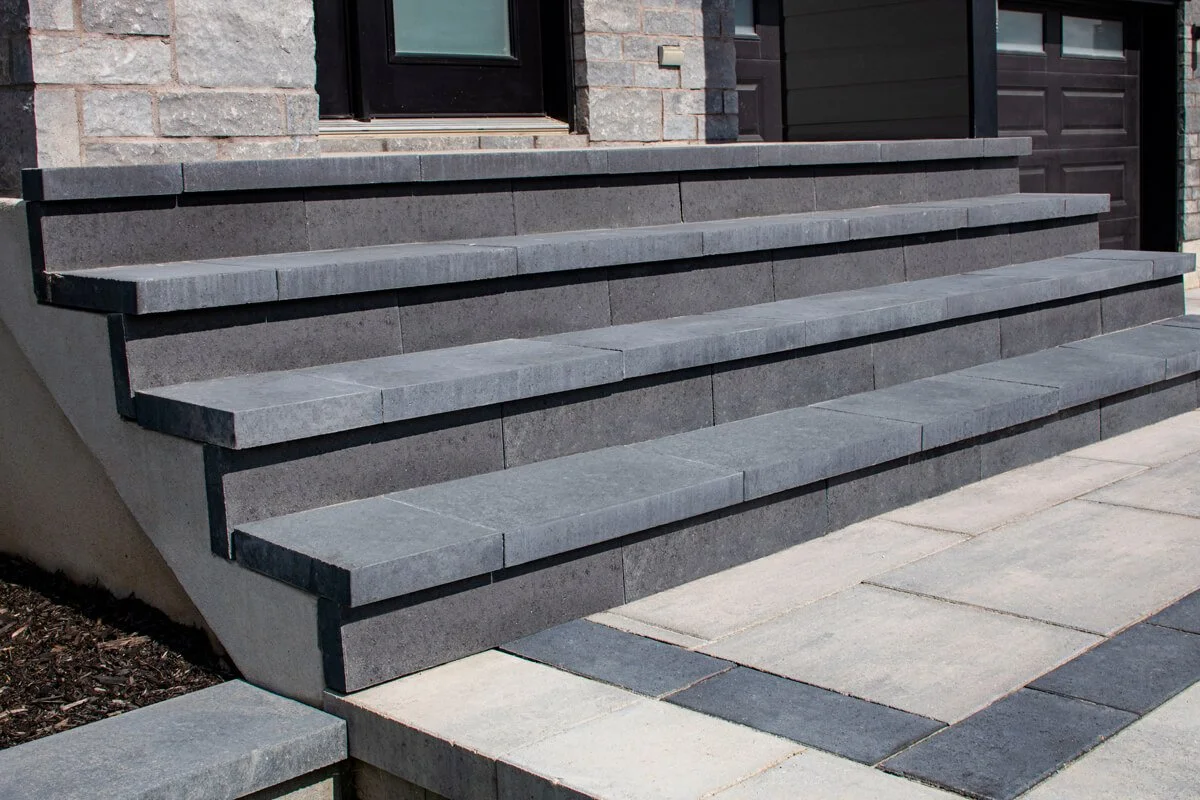 Gray stone front steps and entrance walkway to a building
