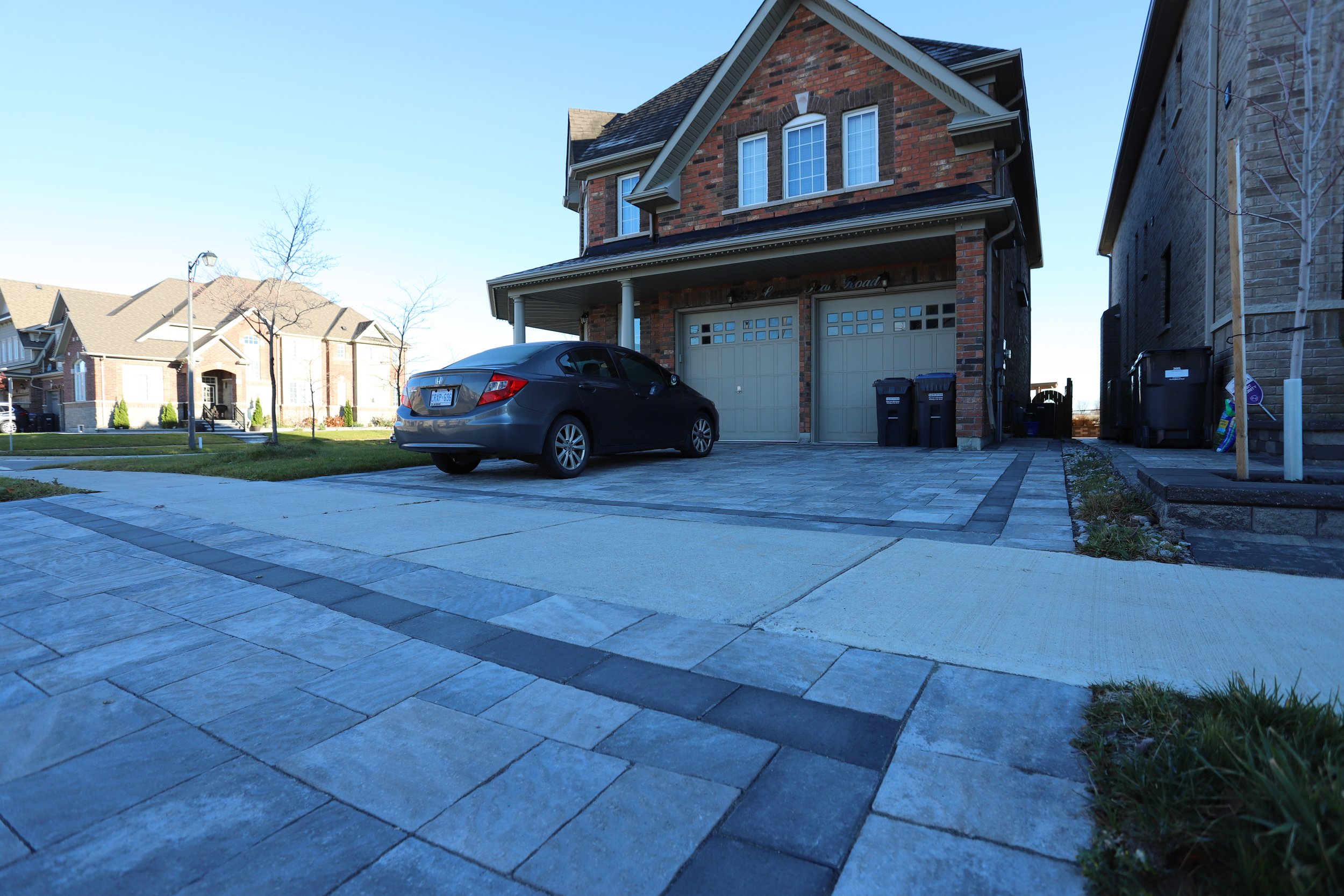 Suburban house with driveway and car
